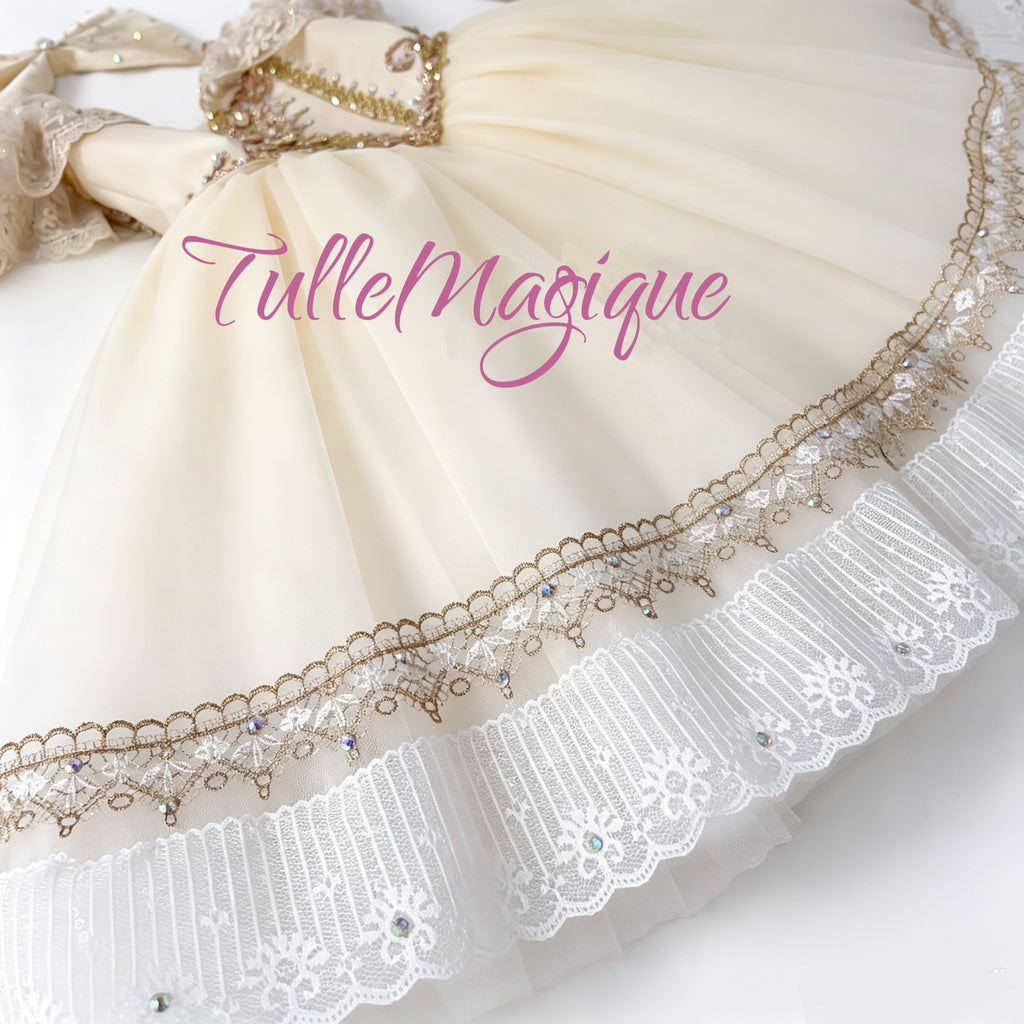 Luxurious champagne cream hue. Adorned with delicate gold lace,  flowing layers of soft tulle, this long dress creates a nostalgic, doll-like aesthetic that radiates under stage lighting.