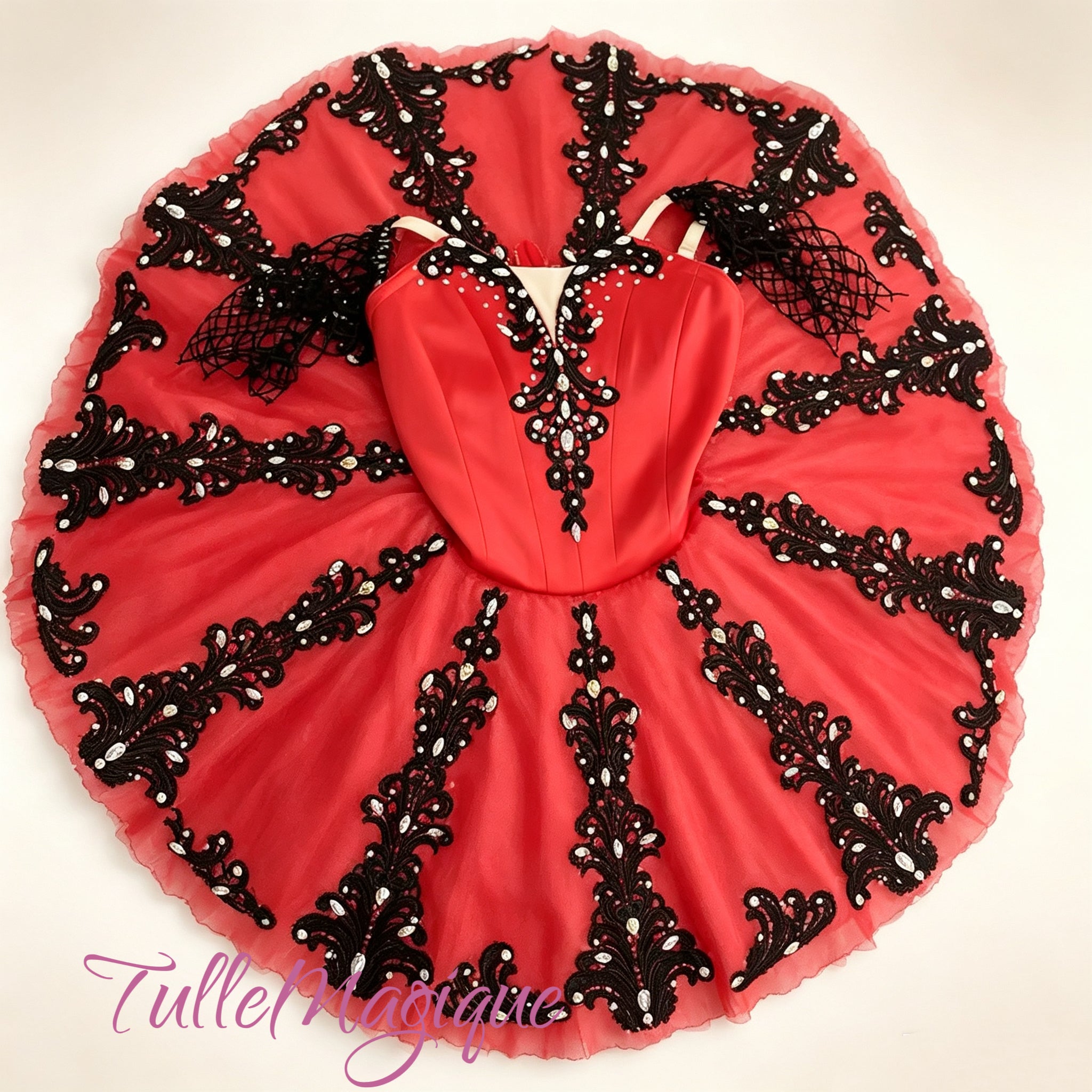 Featuring dramatic,(radial) black embroidery cascading across a brilliant red skirt, this design perfectly captures the bold, Spanish-inspired elegance essential for Kitri.