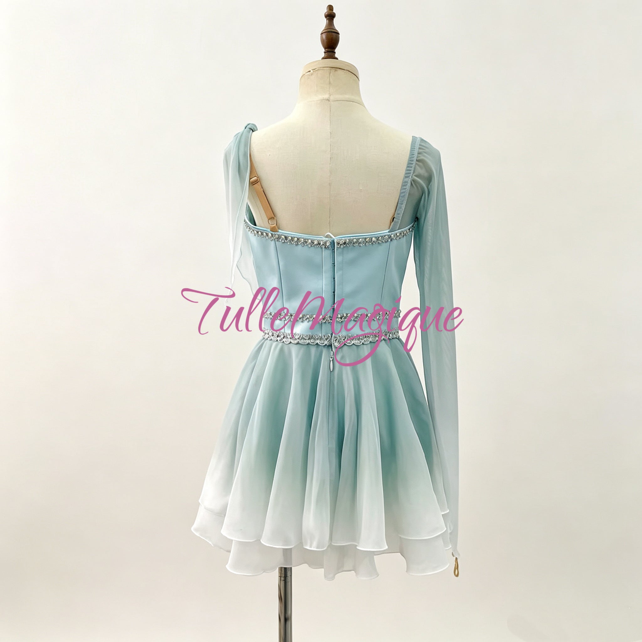 Greek style ballet tunic for Diana or Dew Drop fairy variation, showcasing an aqua blue to white gradient palette, shimmering silver rhinestone scrollwork, and a bouncy tiered wavy short skirt