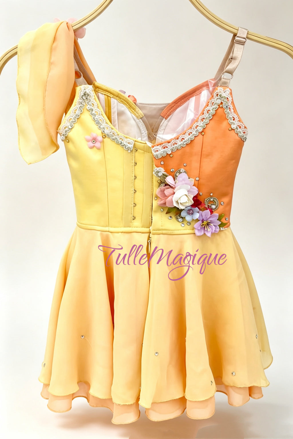 Greek style ballet dress in vibrant yellow and orange, showcasing an asymmetric design with a single flutter sleeve, cross-body gold scrollwork, and a flowy tiered chiffon short skirt