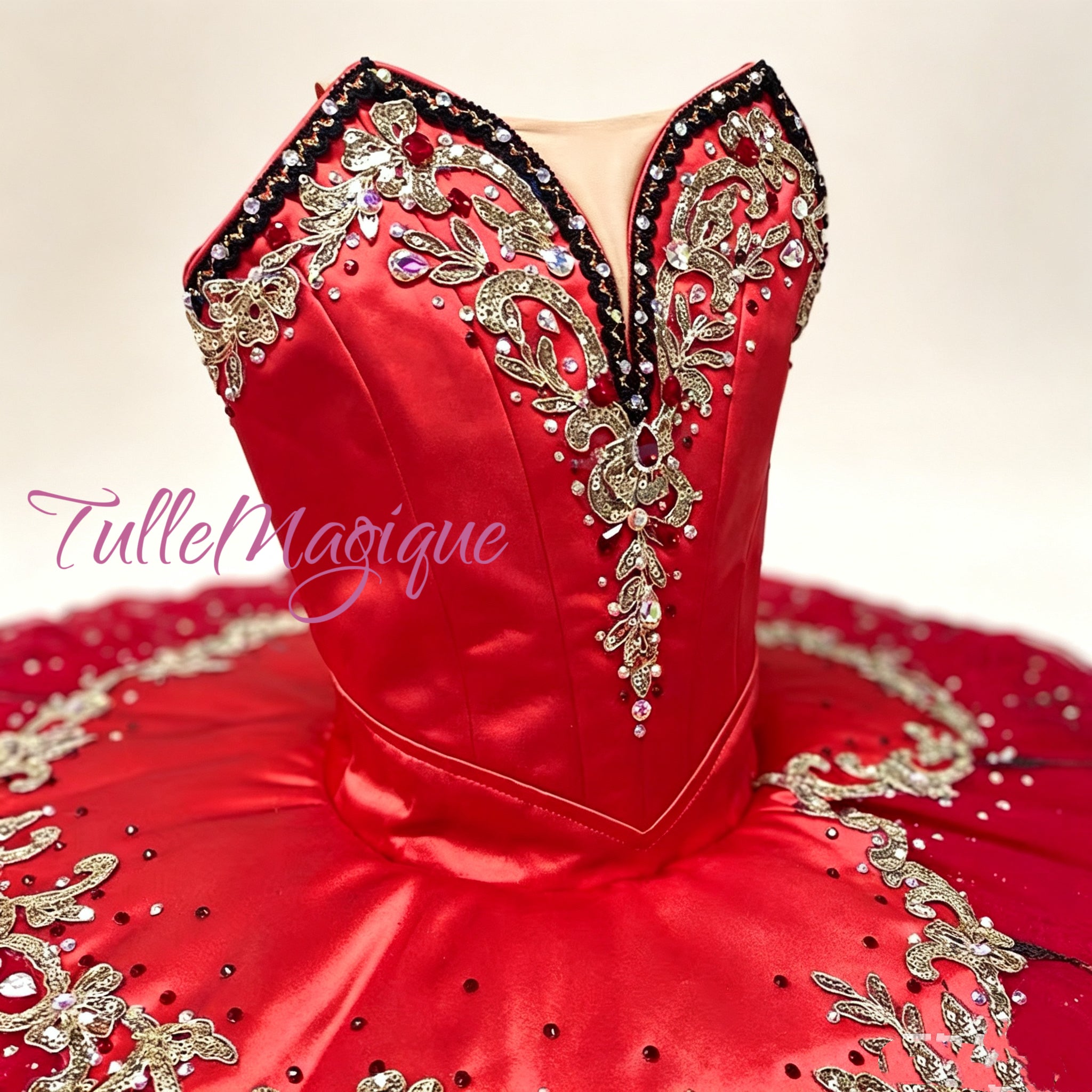 Close-up of hand-beaded gold embroidery on the red bodice of a Paquita or Esmeralda competition ballet tutu.
