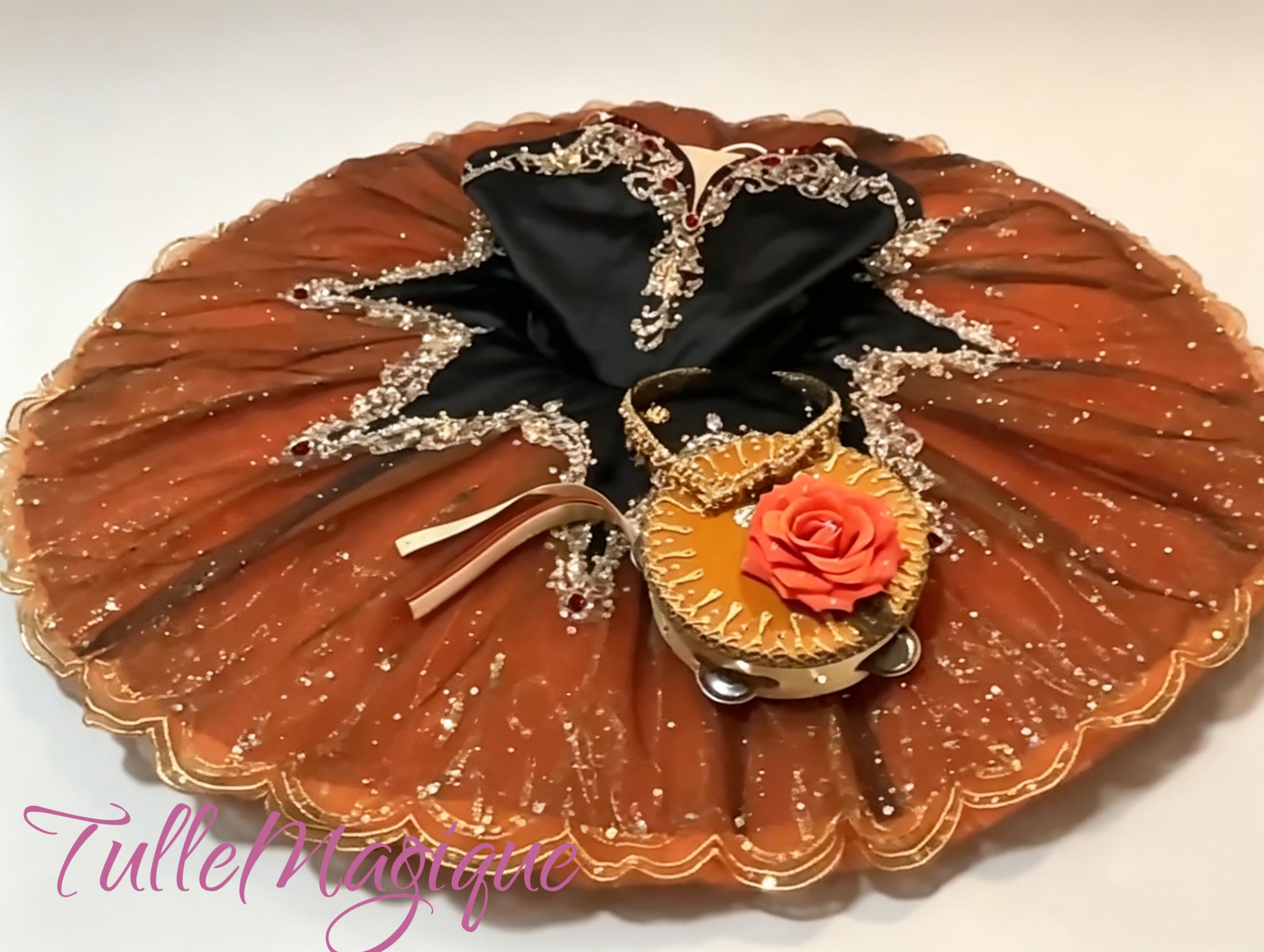 Luxury terracotta and black professional ballet stage costume for a non-traditional classical Esmeralda variation, adorned with gold glitter lace, red crystals, and a custom-made performance tambourine.