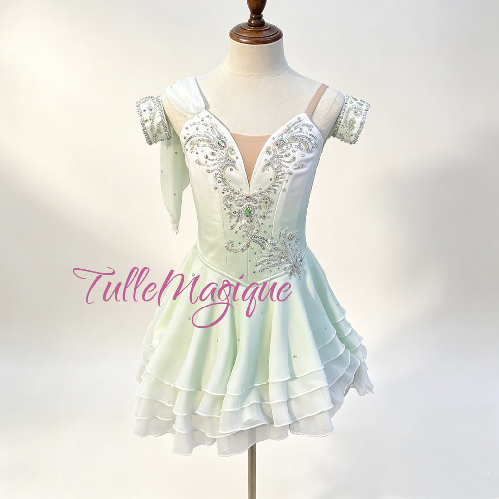 Professional Cupid ballet variation costume, featuring a white to green ombre bodice with symmetrical silver embroidery, a center green crystal, and a bouncy tiered ripple short skirt with rolled hems