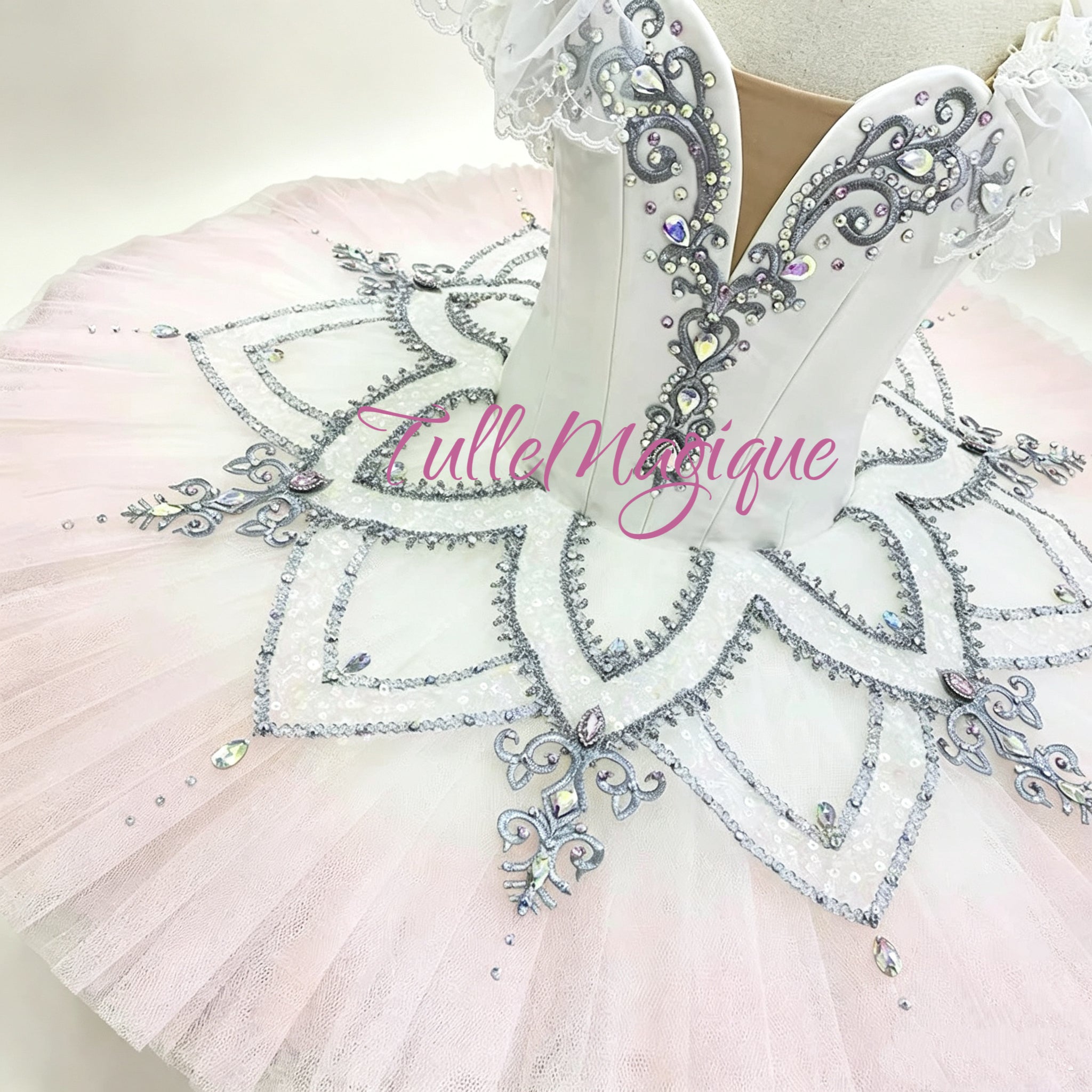 Elegant white ballet tutu for Candide Fairy variation perfect for ballet competitions with silver petal embroidery and crystals on a white professional ballet classical tutu and edge pastal pink tone.