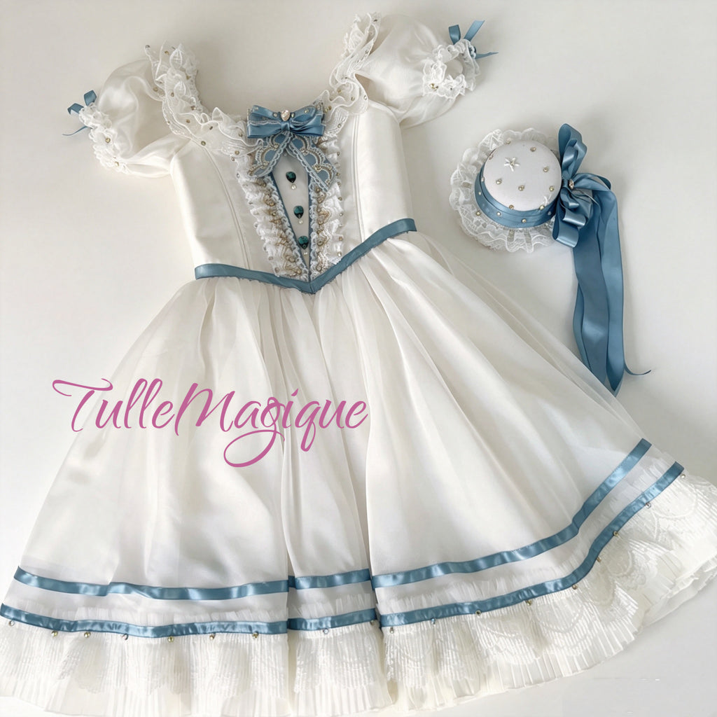 A luxury white and pastel blue Clara Nutcracker ballet dress showcasing a vintage European party dress bodice with lace ruffles, crystal gemstones, and a matching elegant headpiece