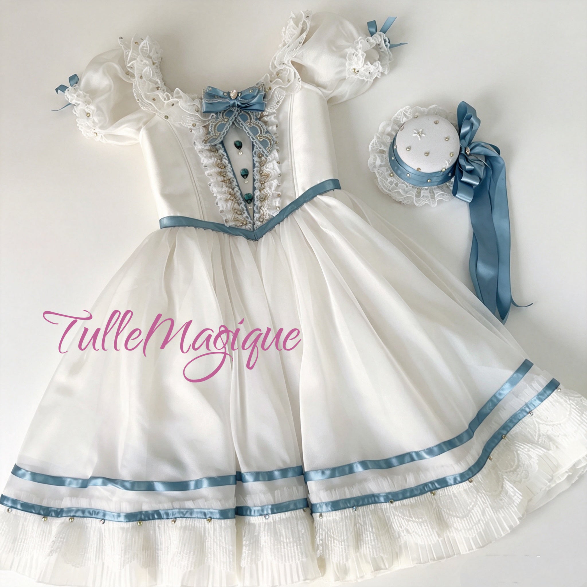 A luxury white and pastel blue Clara Nutcracker ballet dress showcasing a vintage European party dress bodice with lace ruffles, crystal gemstones, and a matching elegant headpiece