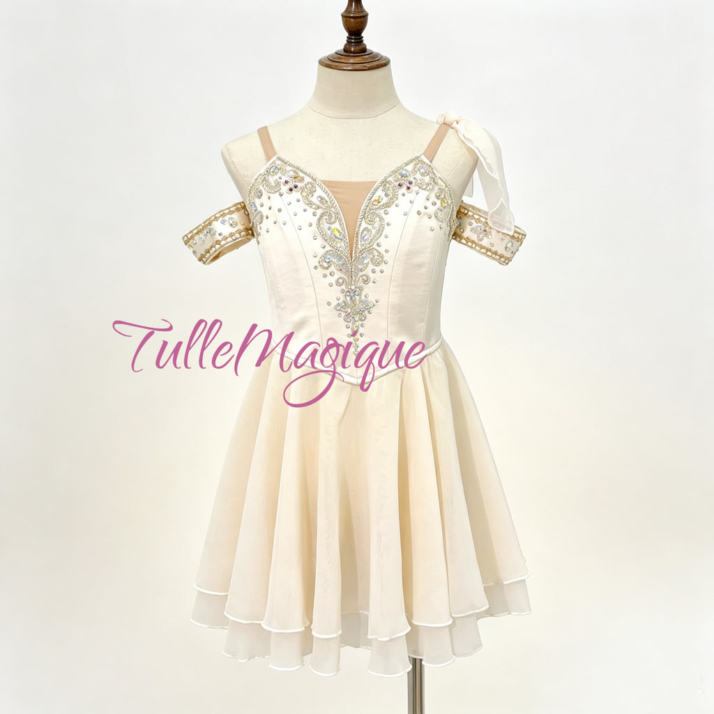 Professional cream-white Cupid variation ballet costume featuring a Grecian chiton style chiffon skirt and silver embellished bodice with crystals for stage performance and YAGP GCD competition 