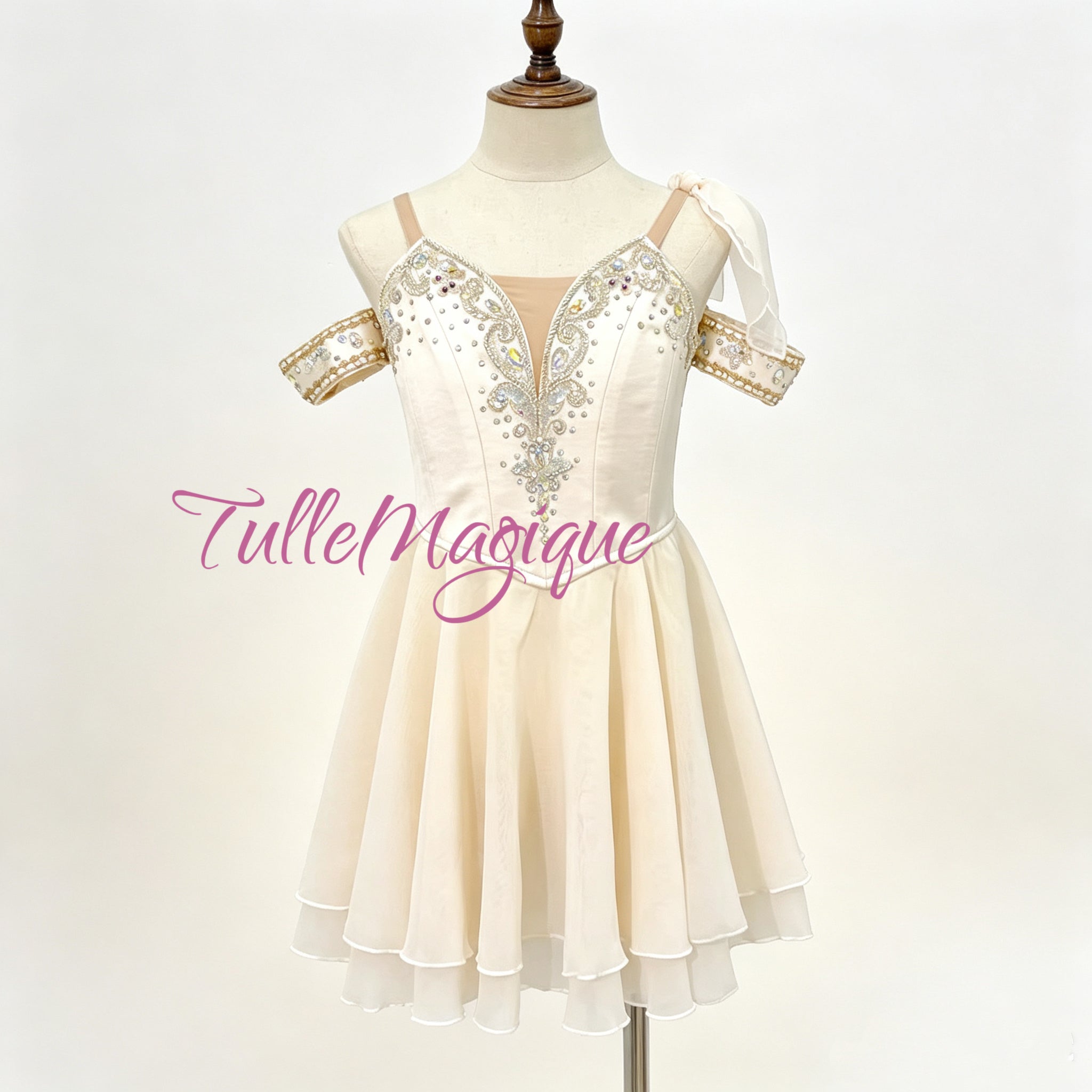 Professional cream-white Cupid variation ballet costume featuring a Grecian chiton style chiffon skirt and silver embellished bodice with crystals for stage performance and YAGP GCD competition 