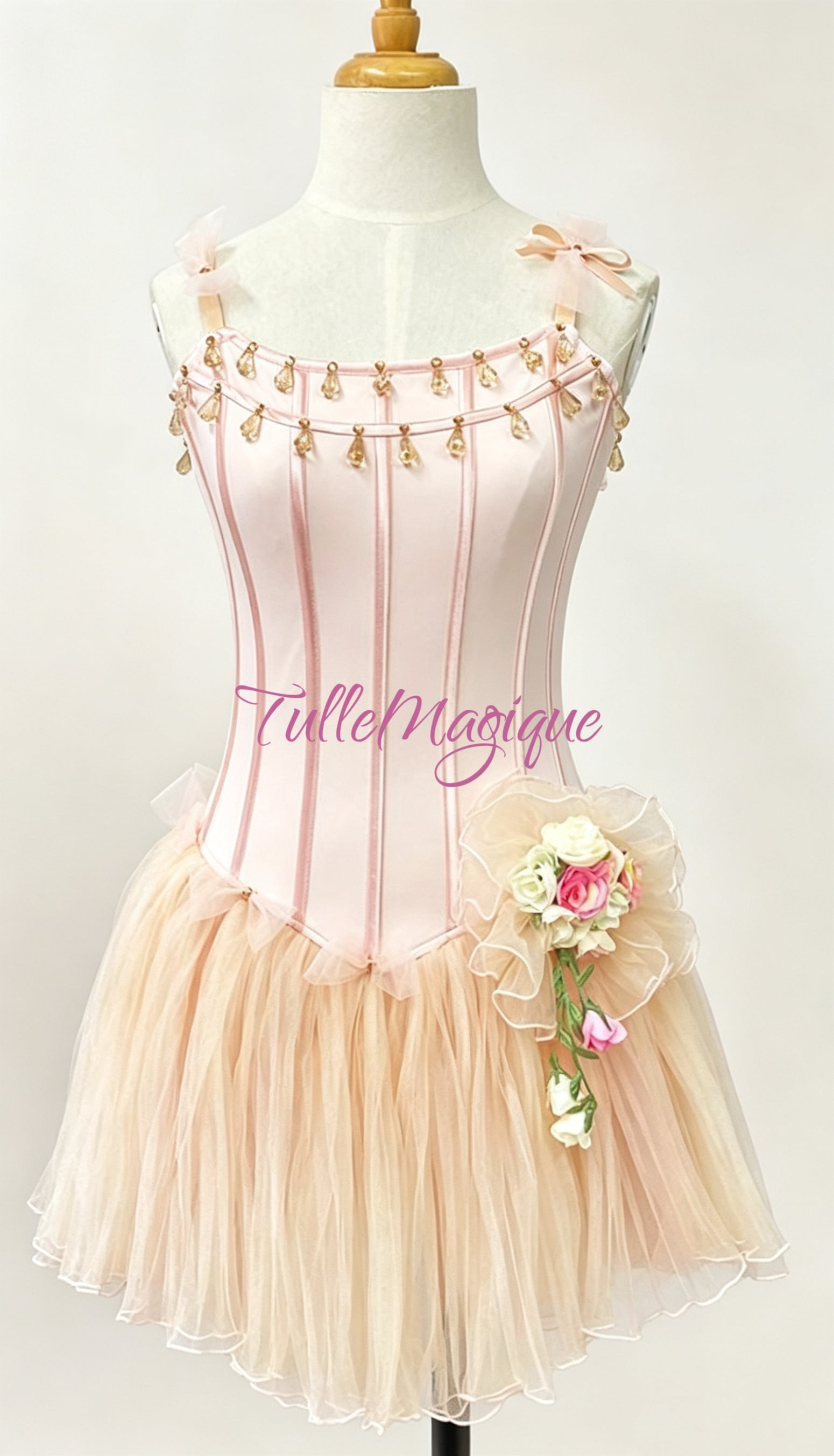Professional Dew Drop fairy ballet variation costume from The Nutcracker, featuring a champagne peach bodice trimmed with hanging teardrop crystals and a soft tulle short tutu with a handmade rose cluster.