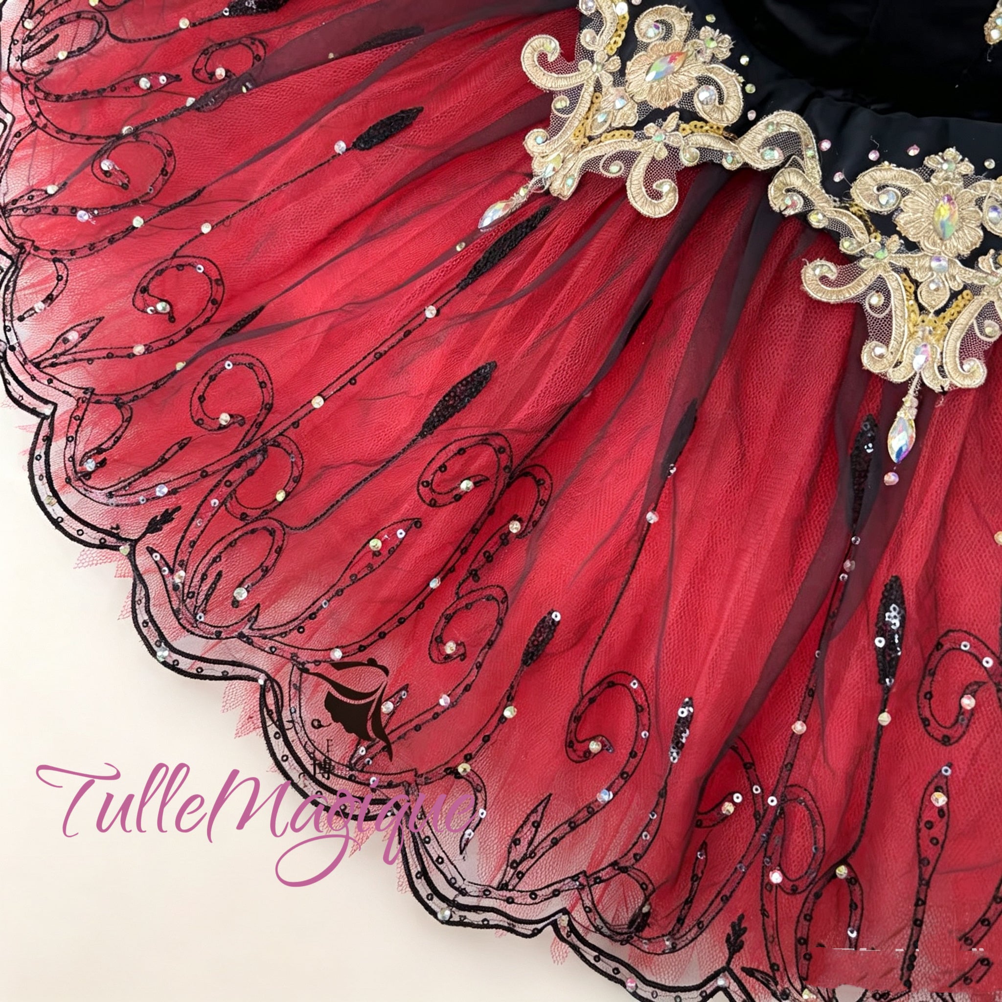 Detailed view of embellished red and black layered skirt for Don Quixote classical ballet performance.