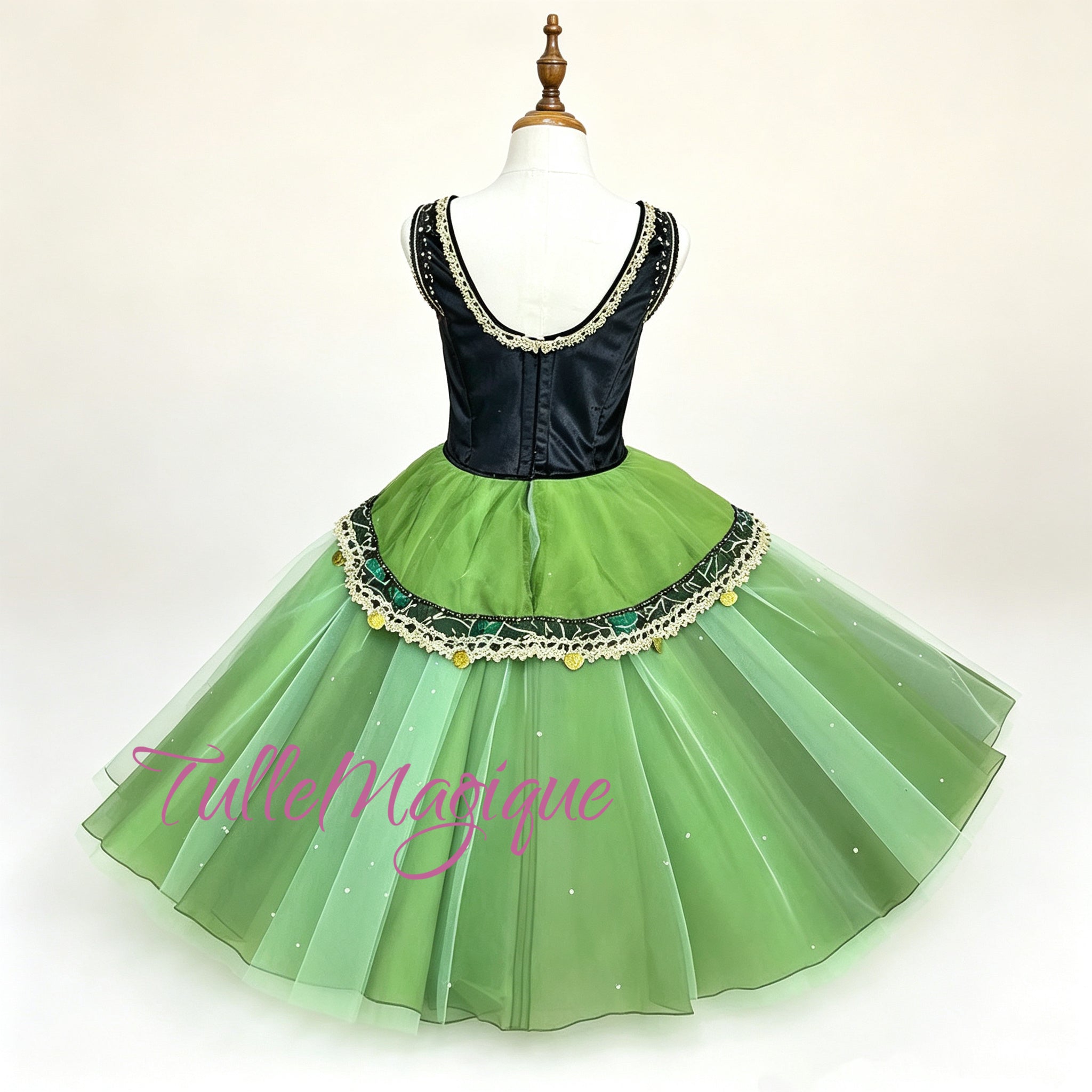 emerald green and black romantic-length ballet tutu with a structured jeweled bodice and asymmetrical peplum.