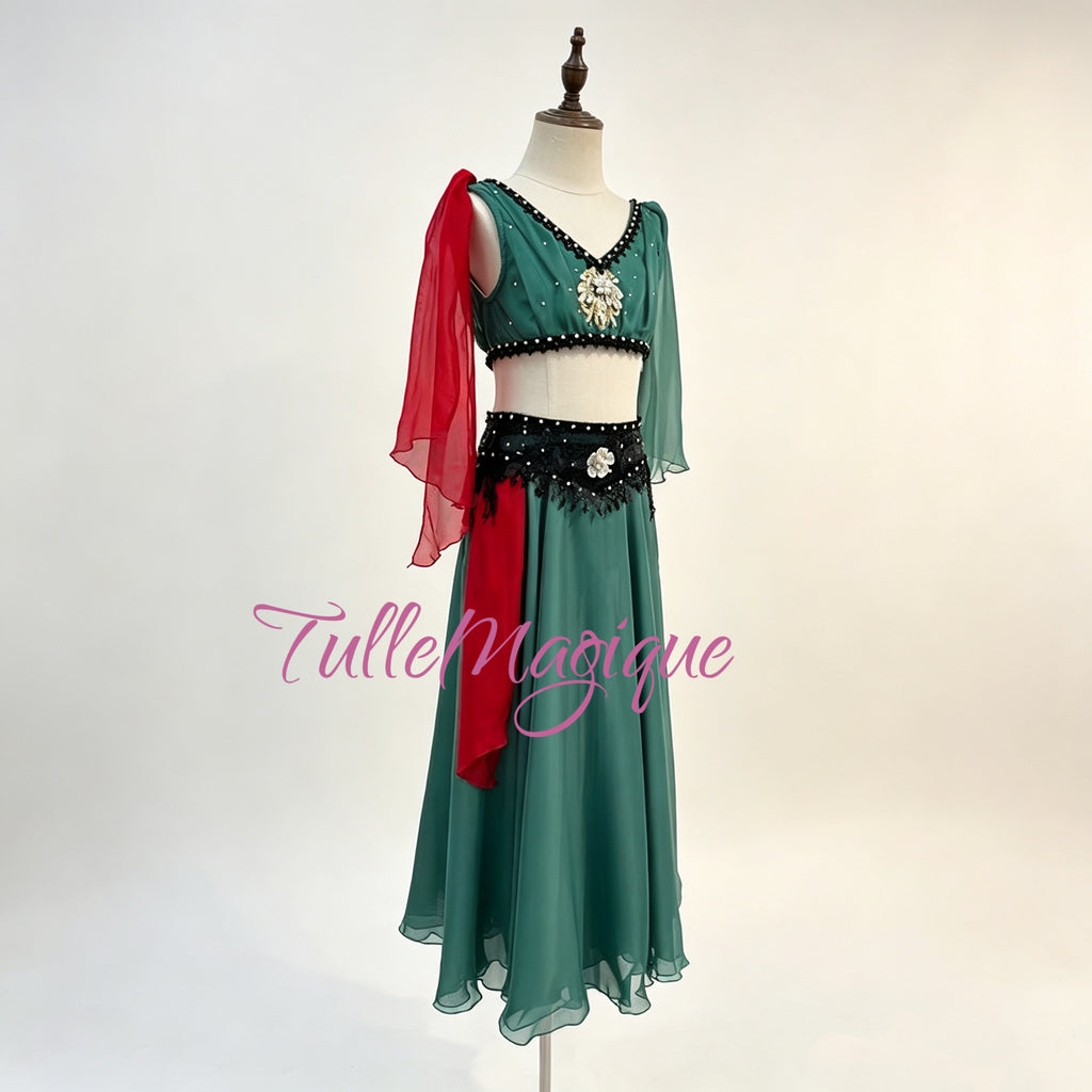 Flowing chiffon ballet character costume with unique green and red color accent for stage performance in Le Corsaire Act I market scene .