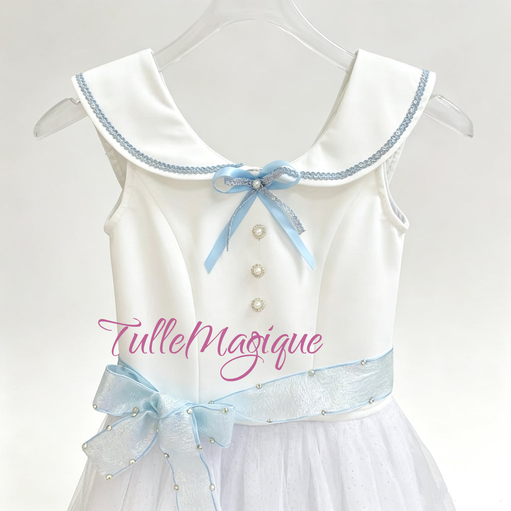 Close-up of the vintage schoolgirl style white bodice from the Graduation Ball costume showcasing the wide collar with blue trim, light blue ribbon bow, and pearl buttons.