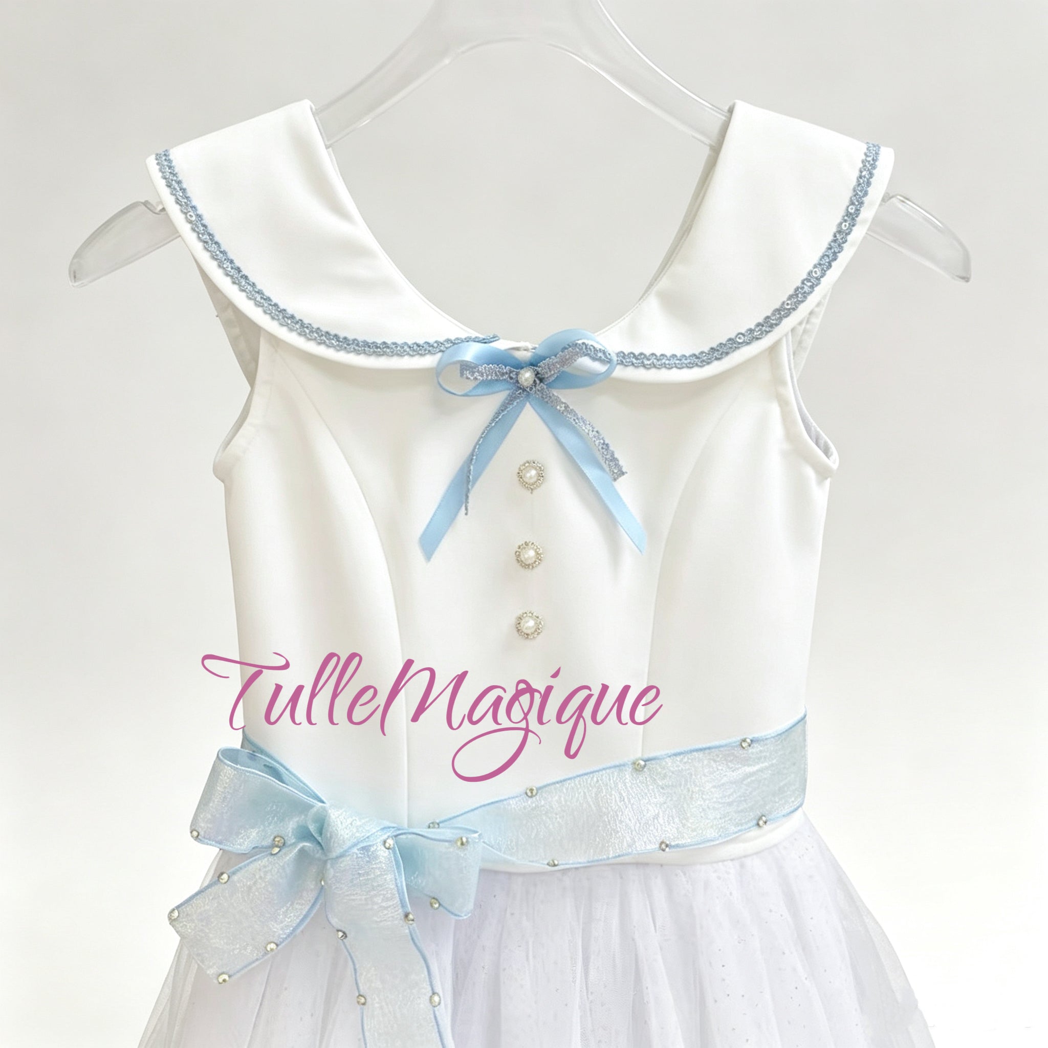 Close-up of the vintage schoolgirl style white bodice from the Graduation Ball costume showcasing the wide collar with blue trim, light blue ribbon bow, and pearl buttons.