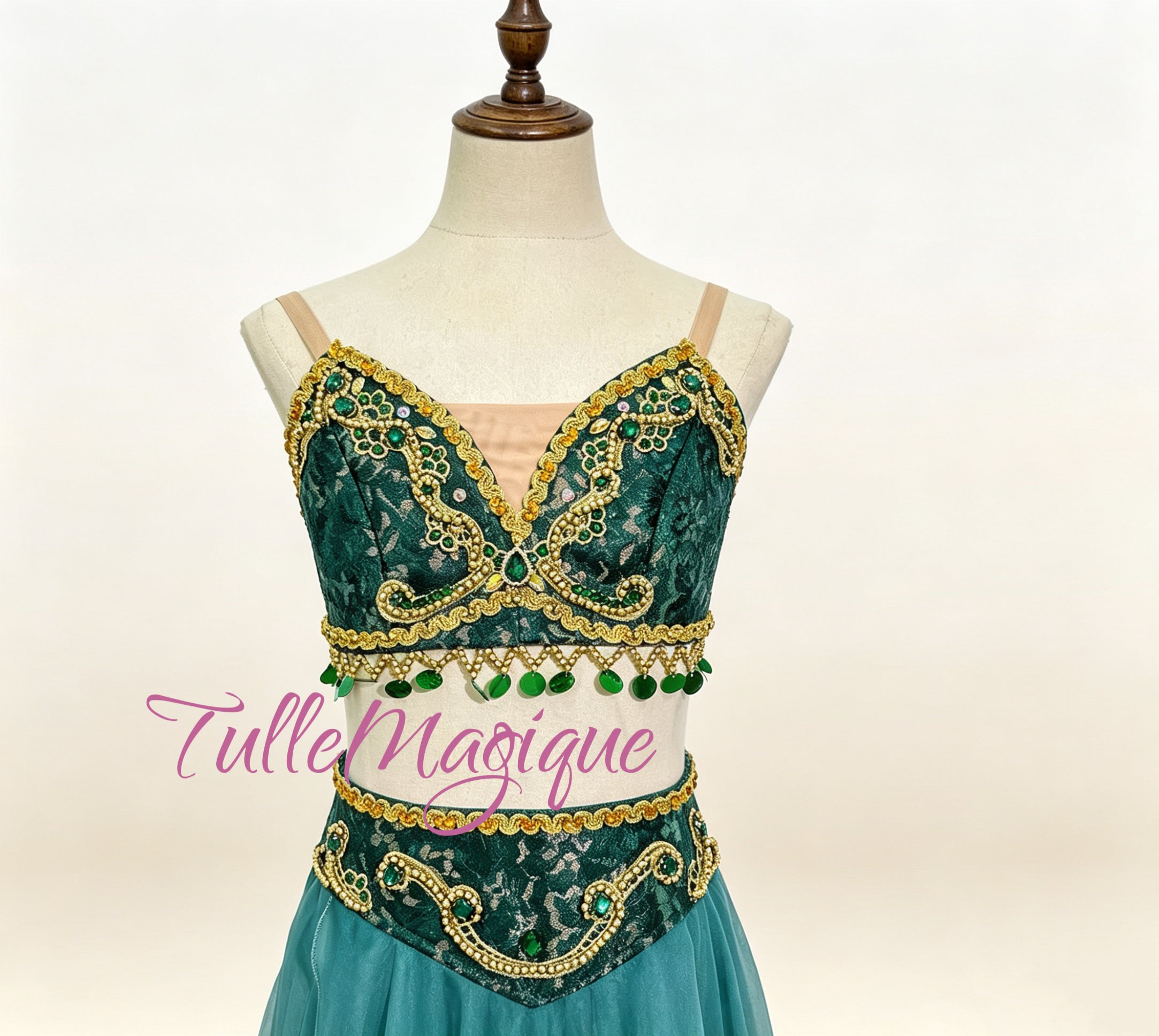 Close-up of green lace bodice with gold embroidery and beadwork on a custom character ballet costume.