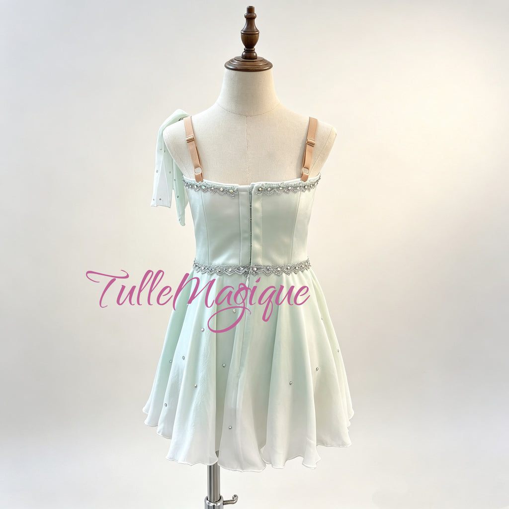 High-quality light green Cupid variation ballet chiton dress with a V-neck bodice, delicate silver scrollwork, and a lightweight flowing short skirt