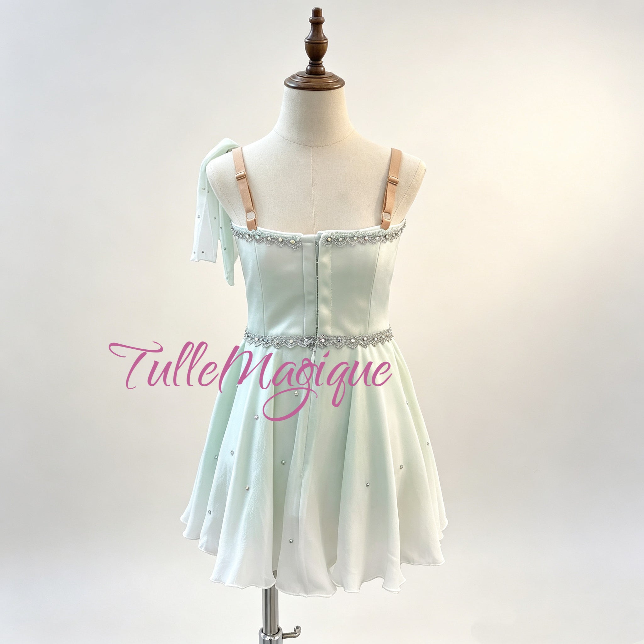 High-quality light green Cupid variation ballet chiton dress with a V-neck bodice, delicate silver scrollwork, and a lightweight flowing short skirt