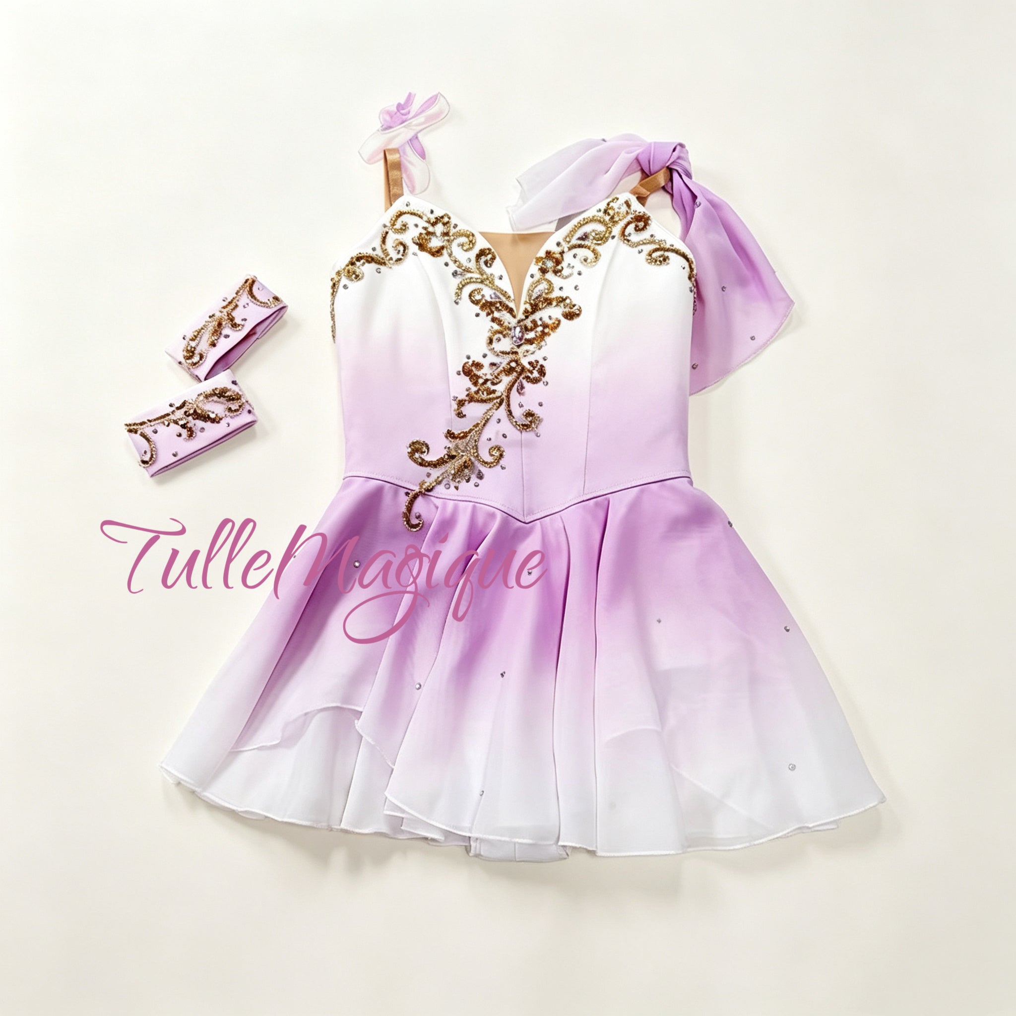 Professional lilac and white Talisman ballet variation costume, featuring a double ombre chiffon chiton skirt, a single shoulder drape, and an asymmetric gold vine embroidery on the bodice