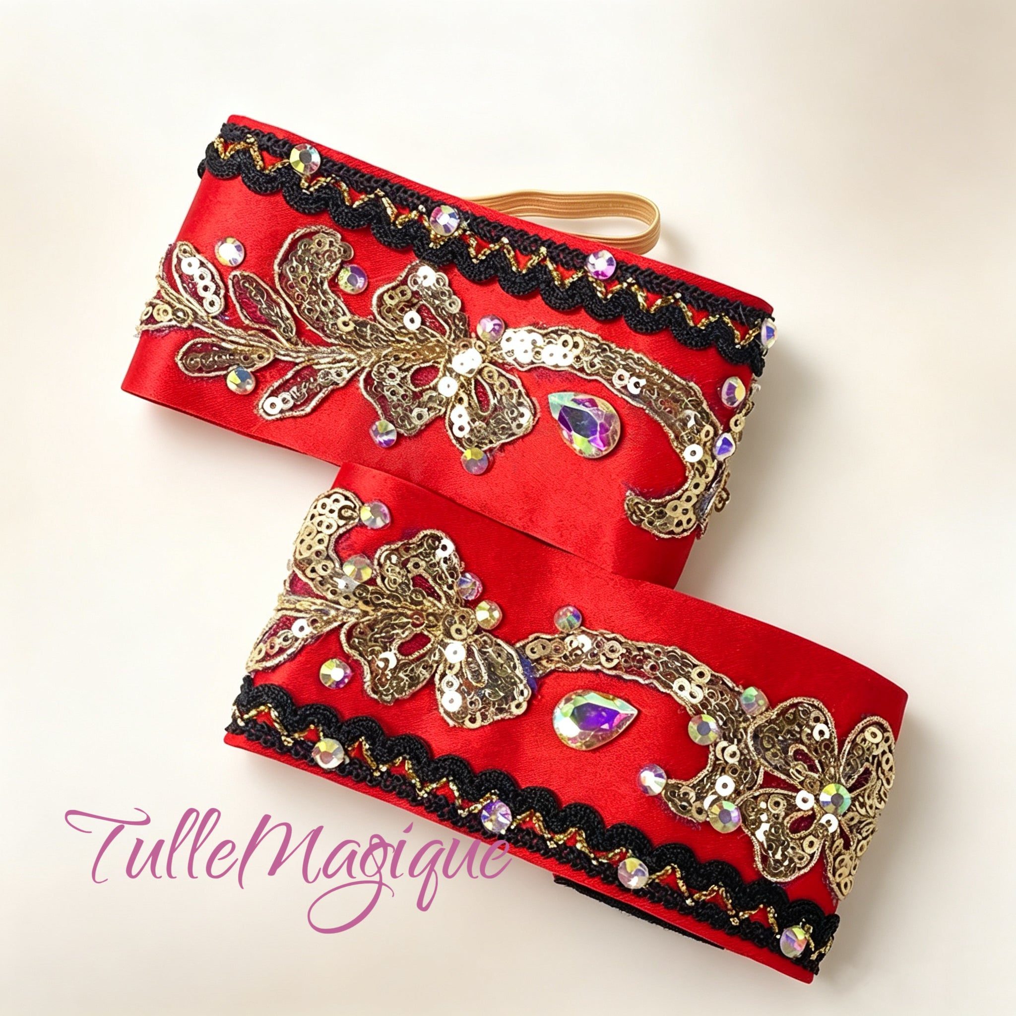 Detailed shot of matching red and gold embellished arm bands for professional stage costume.
