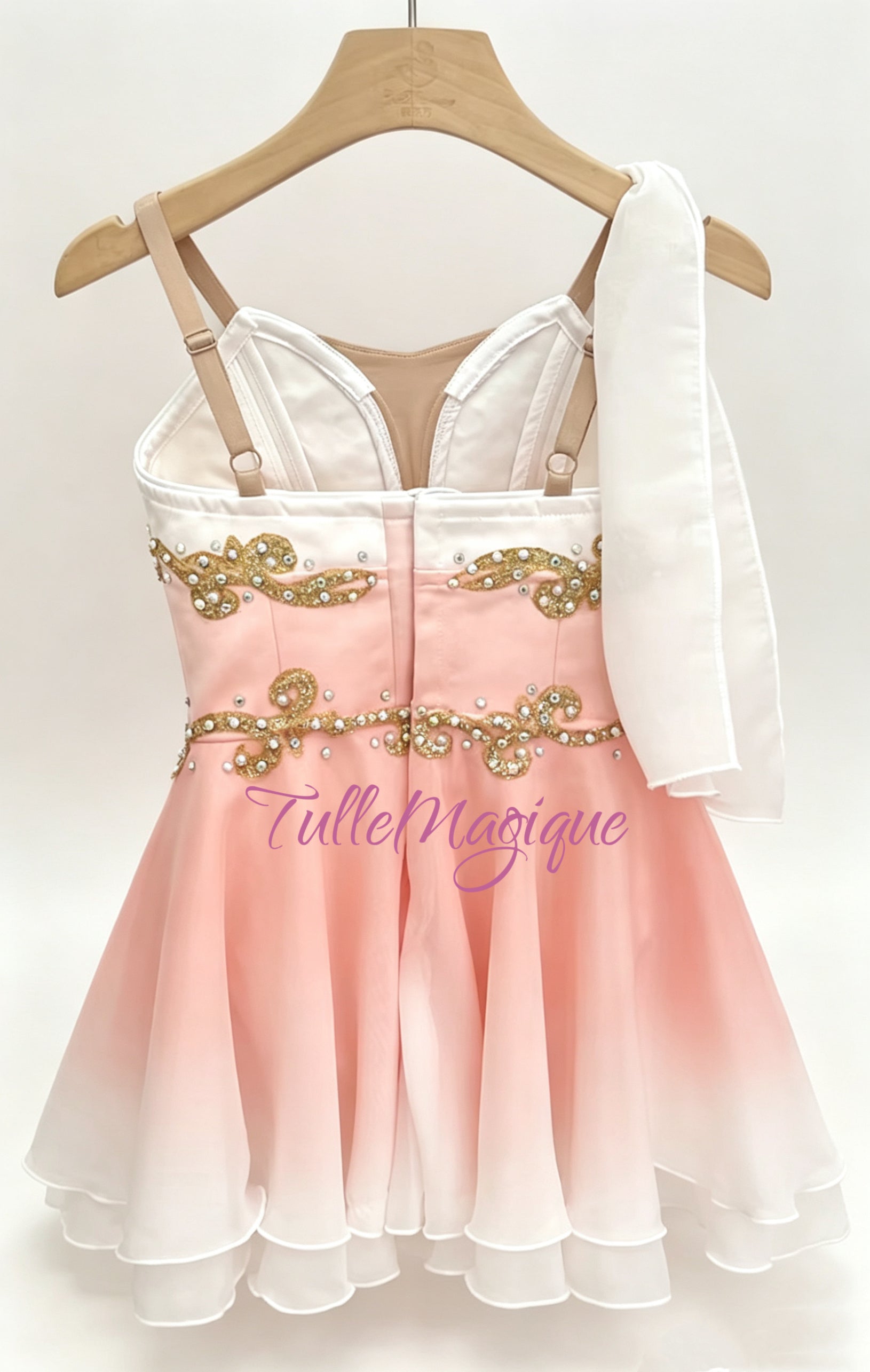 Greek style ballet tunic in peach pink to white gradient, suitable for Awakening of Flora variation, showcasing a detailed bodice with gold scrollwork, a white shoulder drape, and a tiered soft skirt