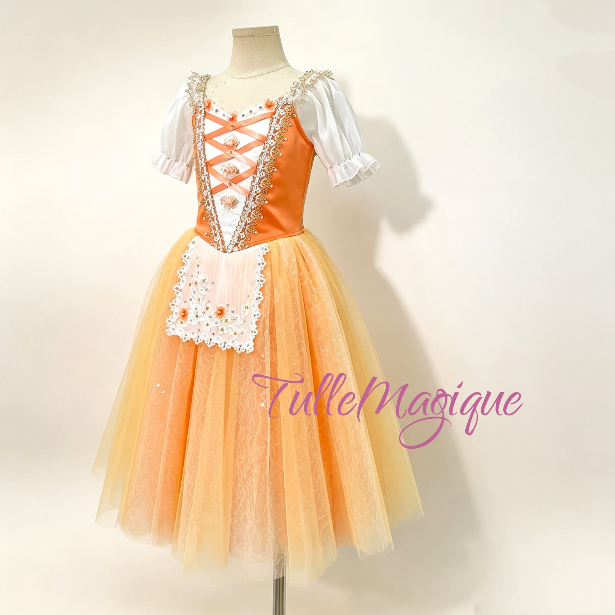 Orange satin ballet bodice showcasing orange criss-cross ribbon lacing, delicate 3D floral accents, and intricate gold lace embroidery. Displaying a white lace-trimmed apron with gold and orange floral embroidery, paired with white chiffon puff sleeves