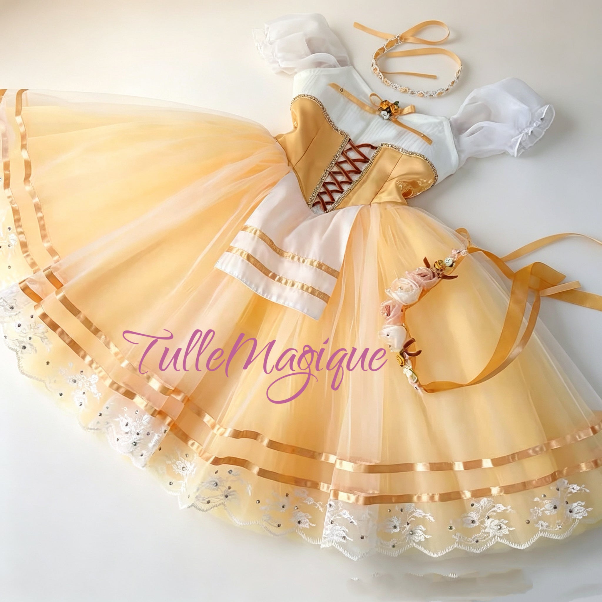 Detailed view of the peach romantic tulle skirt displaying parallel gold satin ribbons, an embroidered white lace hemline with rhinestones, and matching floral headbands.