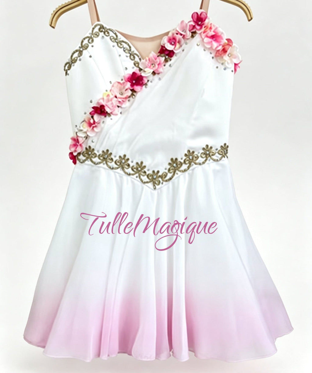 Greek style ballet tunic for lyrical and classical variations, showcasing a white and light pink ombre layered chiffon skirt, adorned with detailed gold embroidery and pink-white flowers.