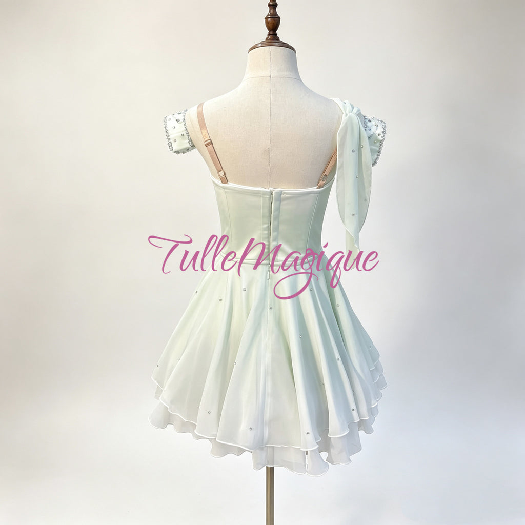 Custom made-to-measure professional classical ballet competition wear, featuring an embellished sweetheart neckline with a prominent green rhinestone, paired with a fluffy tiered ripple chiffon short skirt.