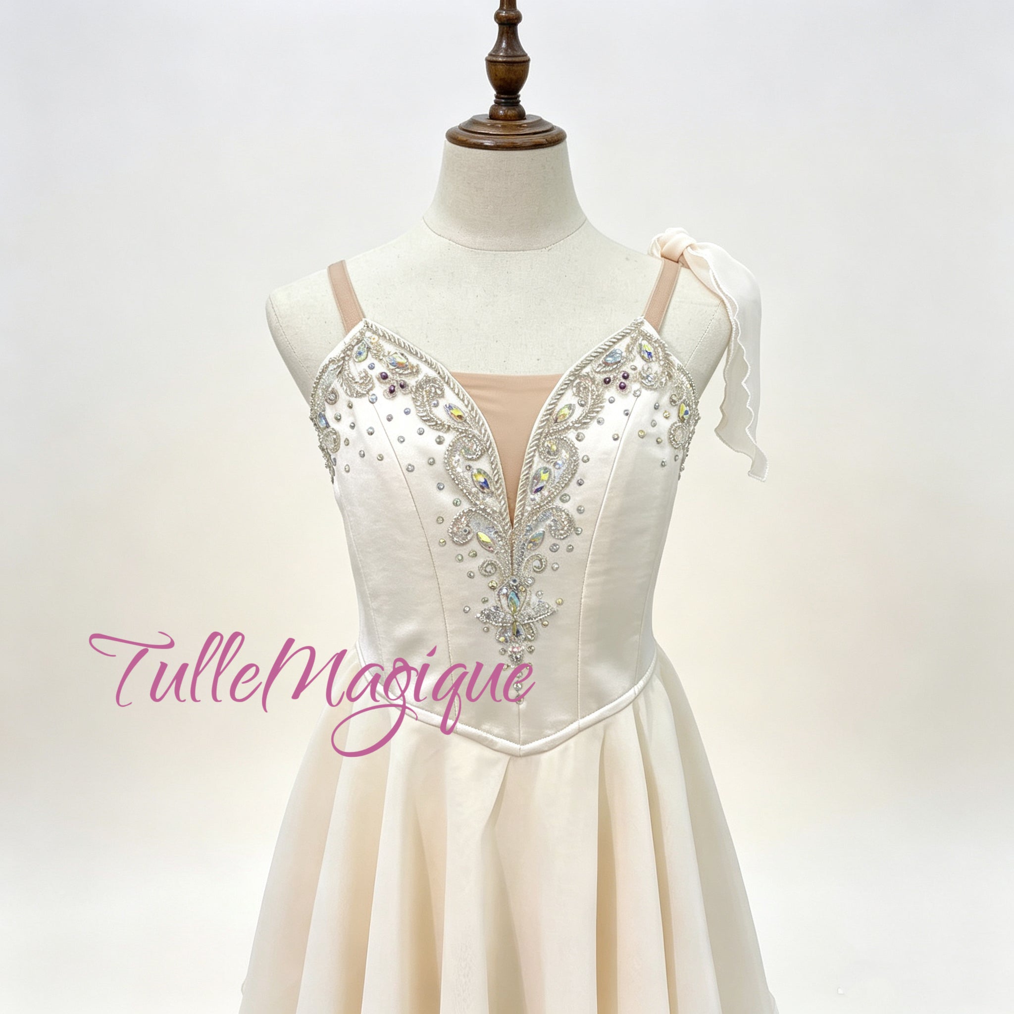 Custom made-to-measure professional ballet stage wear in Greek style, showing a detailed view of the crystal-encrusted bodice and flowy tiered chiffon skirt on a mannequin