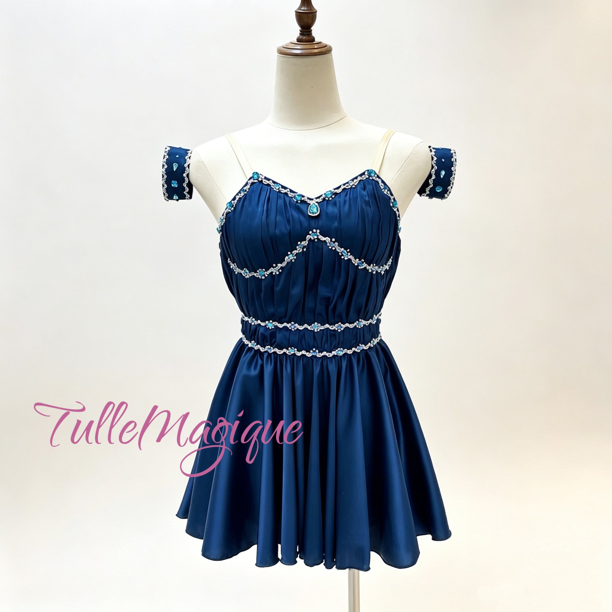 professional lyrical stage wear in midnight blue, detailed with shimmering rhinestone wave patterns on a custom mannequin.⁠