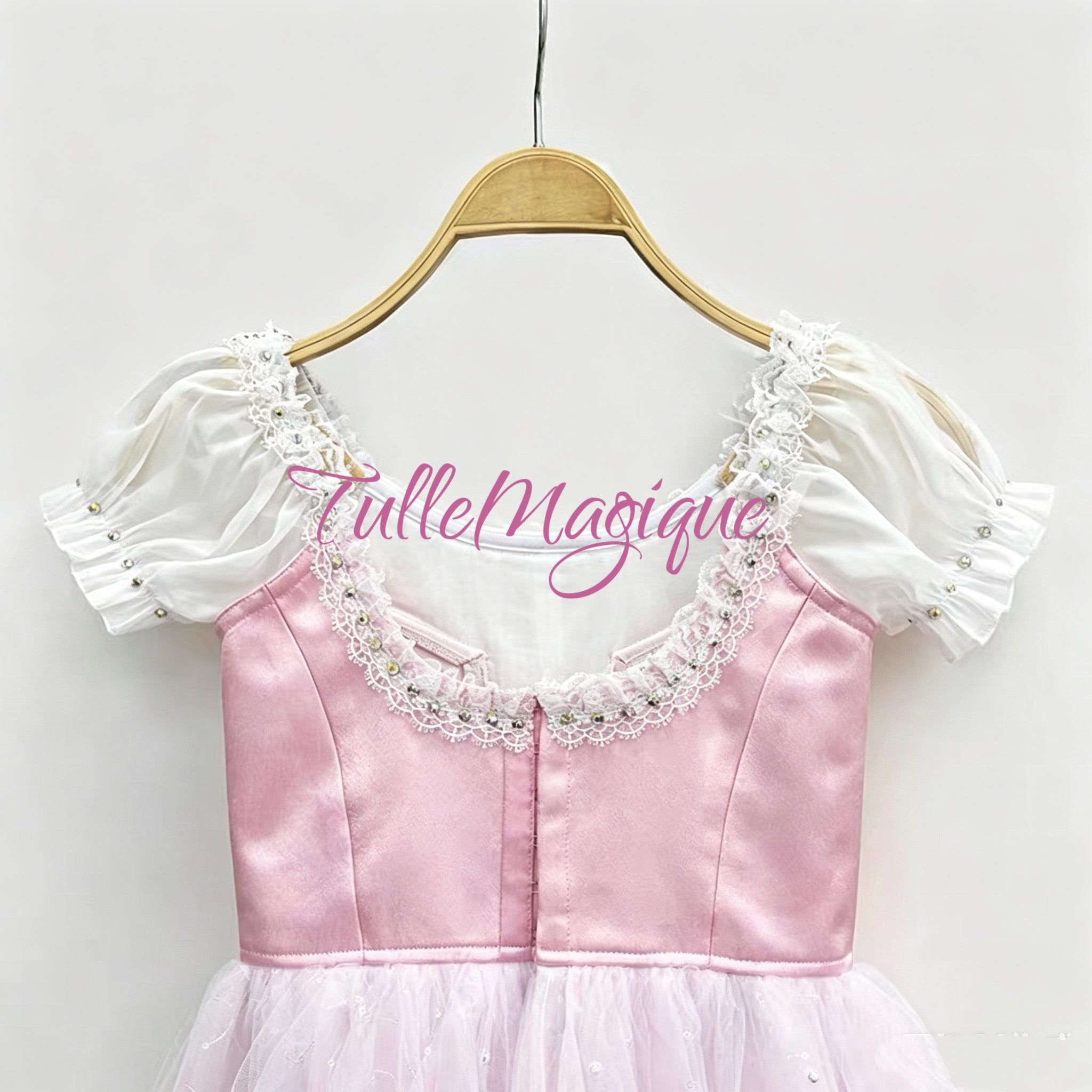 Close-up of the back view of the pink peasant ballet bodice displaying the heavy-duty multi-row adjustable hooks and eyes closure and professional inner support structuring.