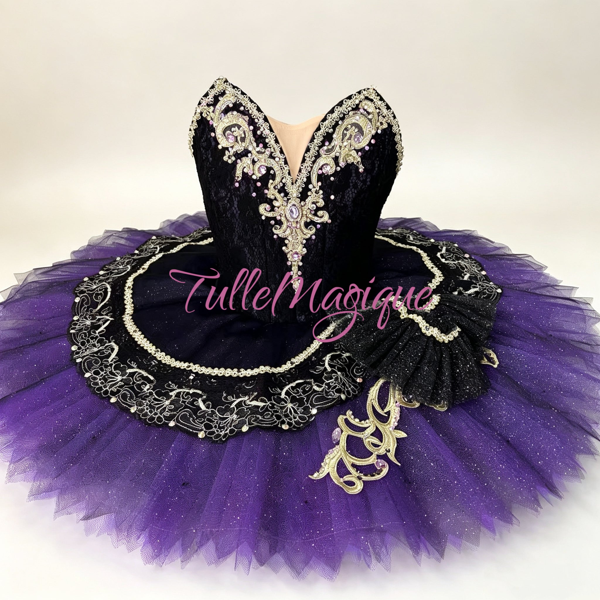 Luxury classical ballet tutu for the Carnival of Venice (Satanella) variation, featuring a dramatic black lace bodice with gold Baroque details and a brilliant violet pancake skirt for international competitions.