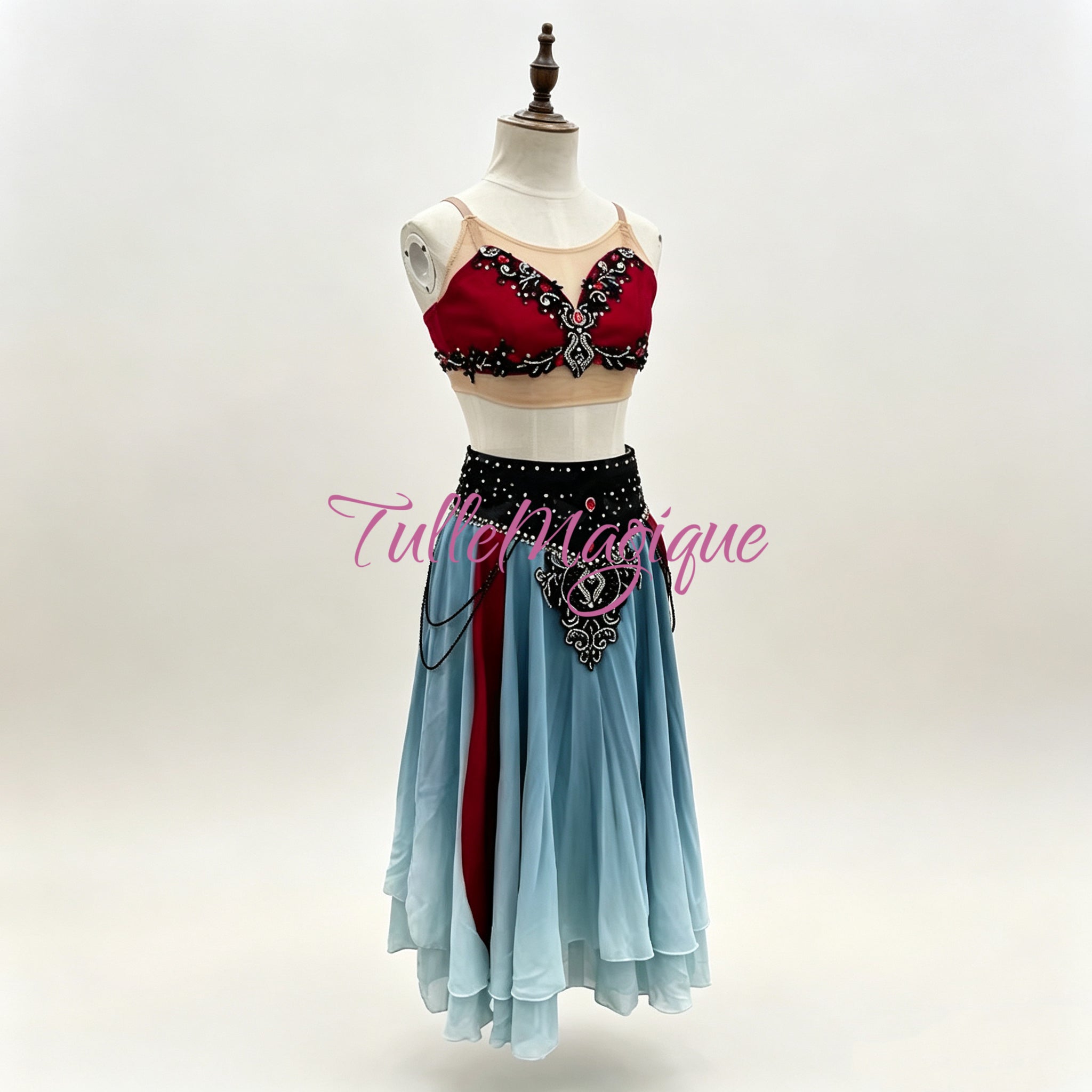 Close-up of black embroidery and red bodice detailing on a custom character ballet costume.
