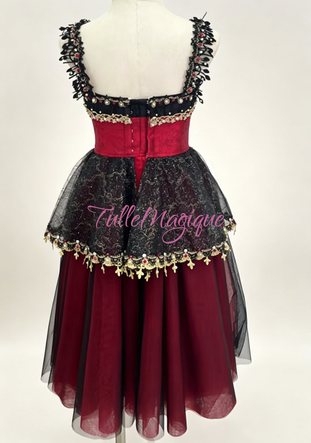 Dramatic red and black romantic-length ballet tutu featuring a jeweled bodice and scalloped black glitter-lace peplum.
