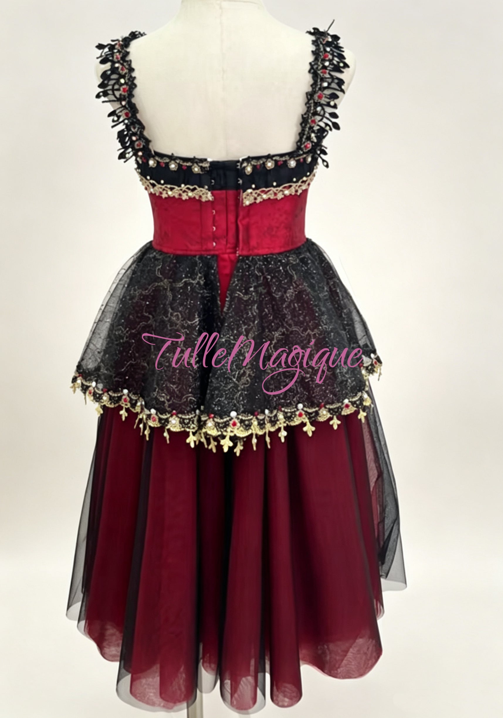 Dramatic red and black romantic-length ballet tutu featuring a jeweled bodice and scalloped black glitter-lace peplum.