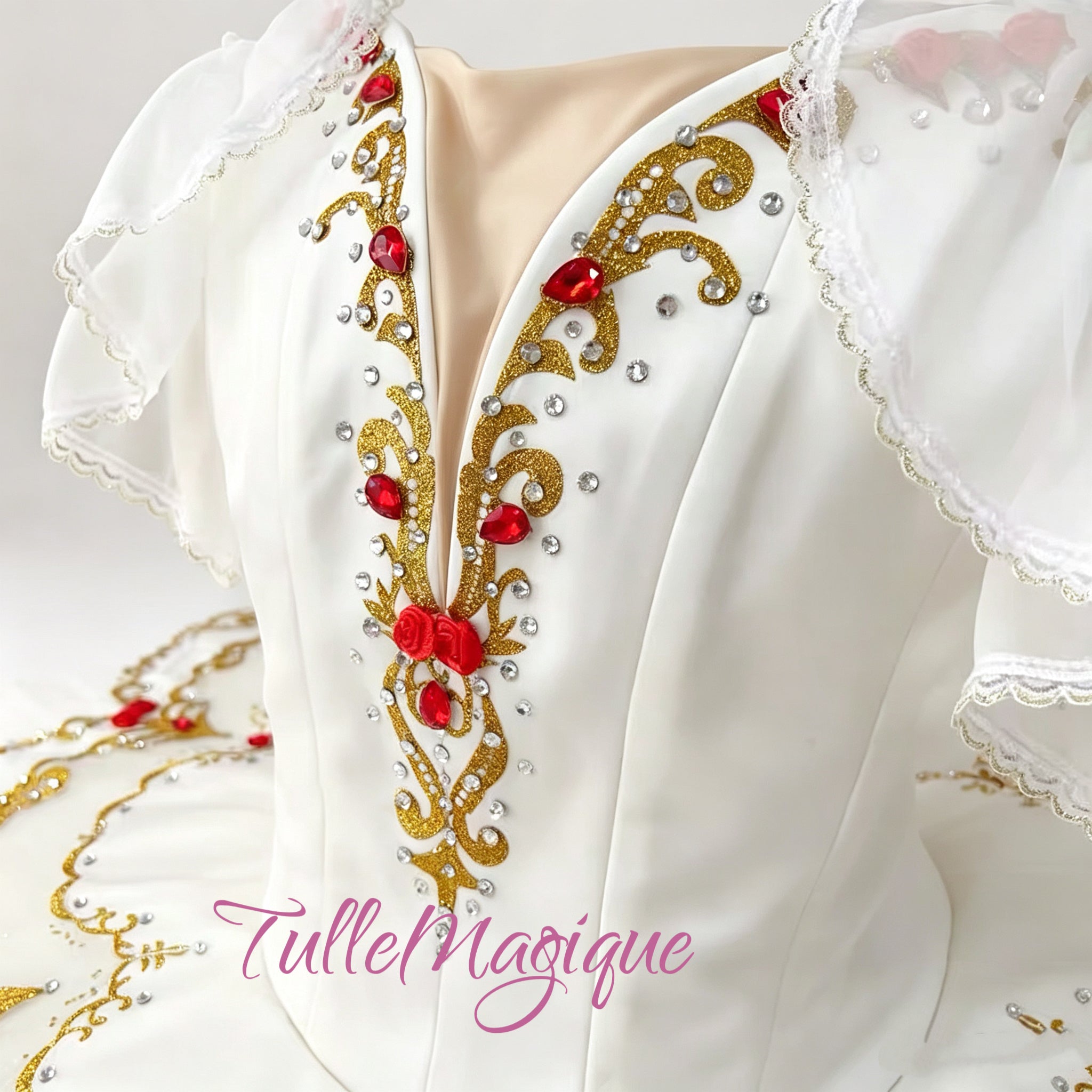 white classical tutu with intricate gold scrollwork and red gemstone accents.