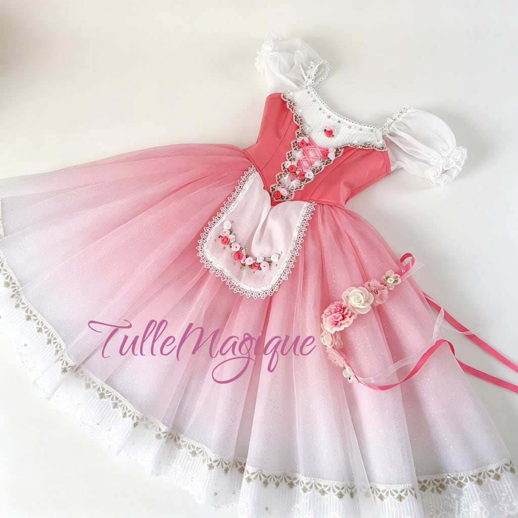 Flat lay full view of a professional rose pink and white peasant ballet costume featuring a pink satin bodice with ribbon lacing, an embroidered rose apron, and a matching floral headpiece.