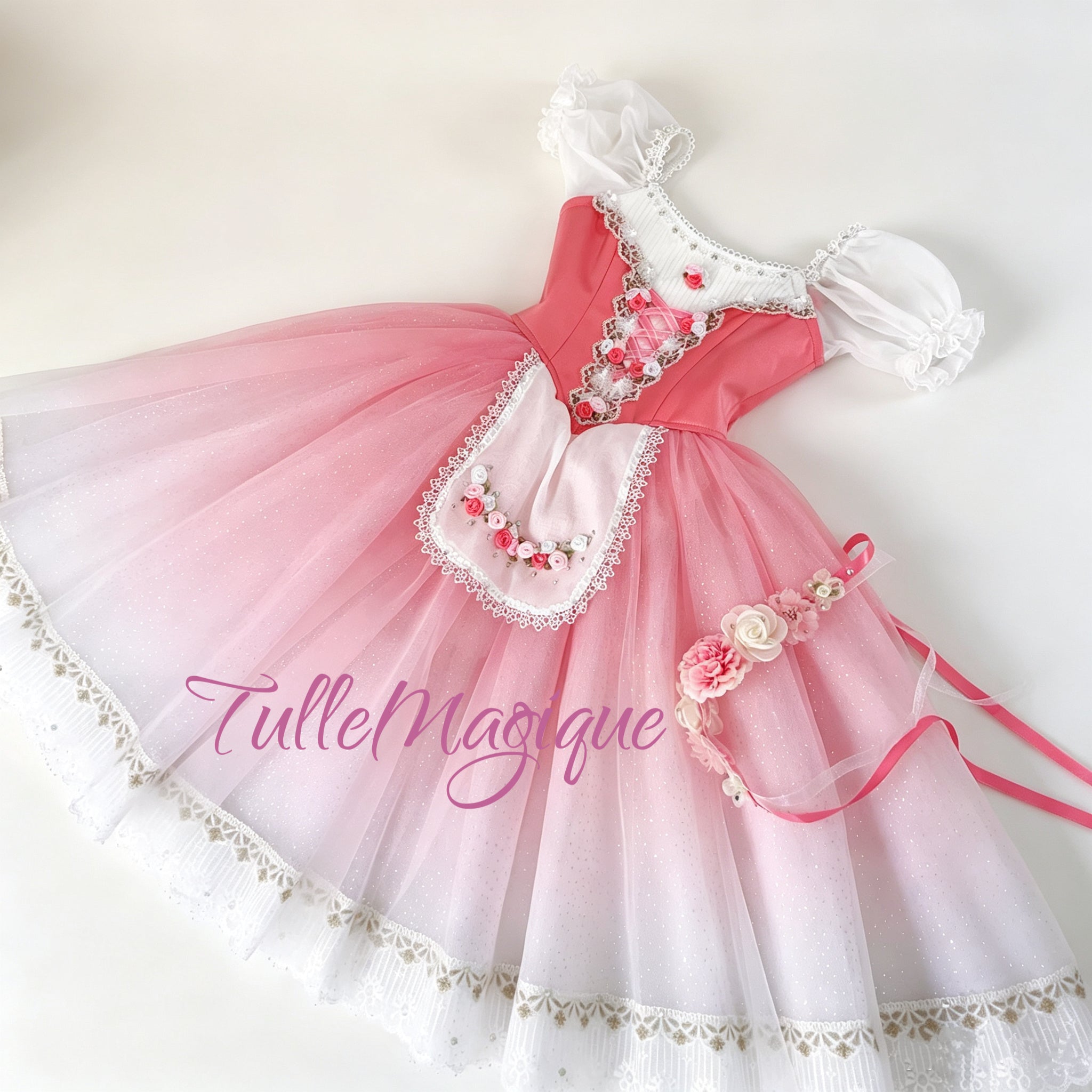 Flat lay full view of a professional rose pink and white peasant ballet costume featuring a pink satin bodice with ribbon lacing, an embroidered rose apron, and a matching floral headpiece.