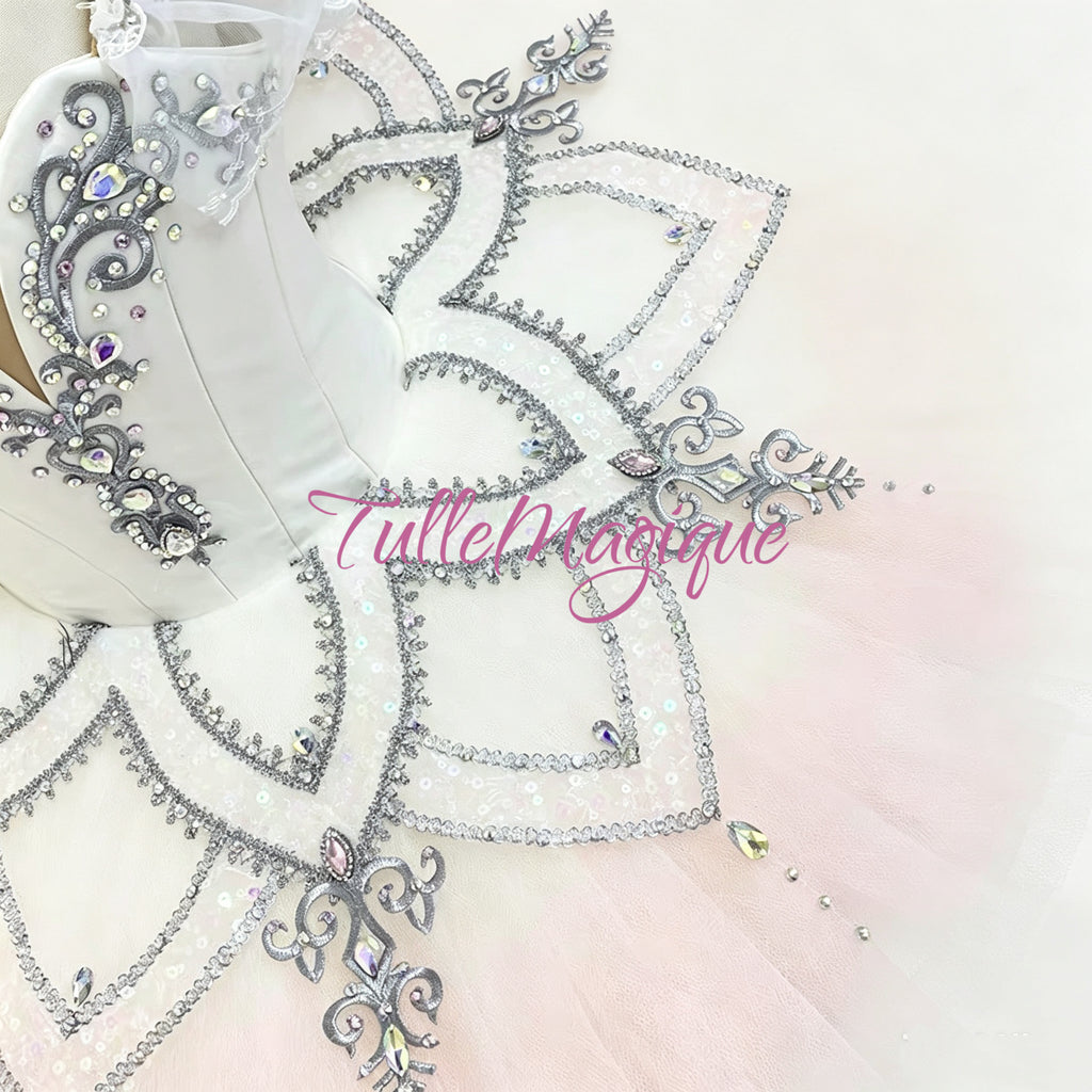Detailed view of silver petal embroidery and crystals on a white professional ballet tutu