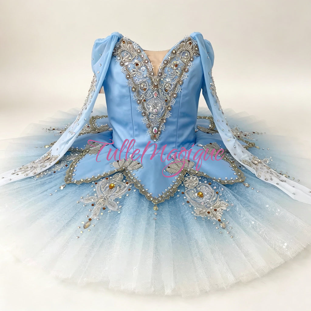 A light blue ballet tutu dress with silver and white beaded embellishments, featuring a V-neck bodice, long sheer sleeves. Professional classical ballet tutu for Snow Queen and Bluebird variations.