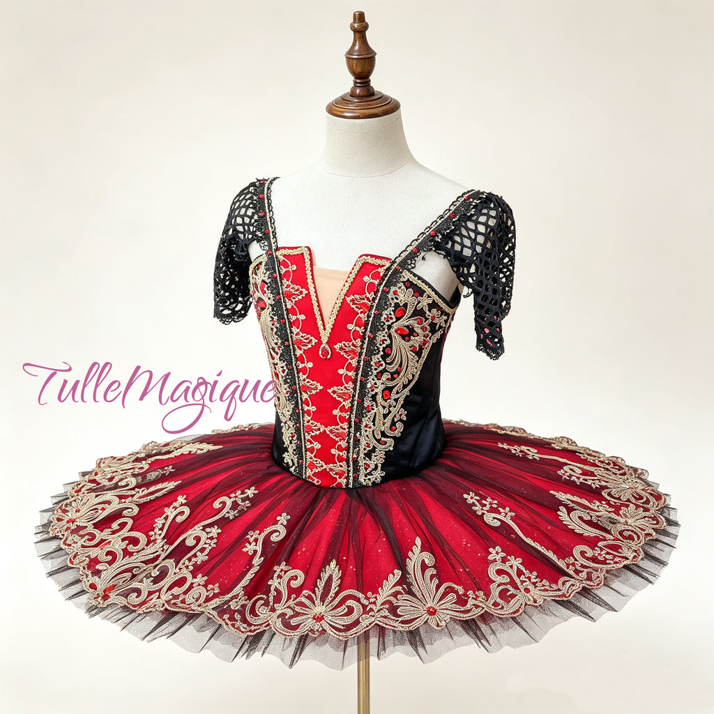 Professional red and gold classical ballet tutu for Paquita or Spanish dance repertoire, featuring a red-black paneled corset bodice with heavy gold baroque embroidery and black mesh sleeves for YAGP.