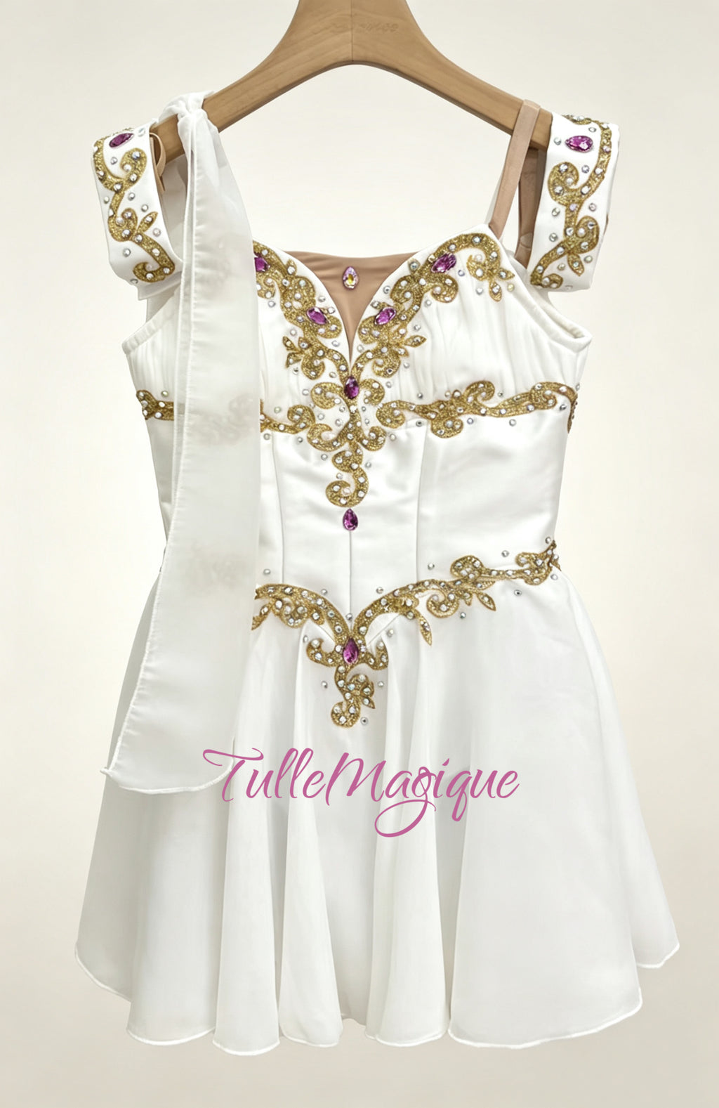 Professional Talisman ballet variation costume in white, featuring heavy gold filigree embroidery adorned with vibrant magenta rhinestones and a signature shoulder drape