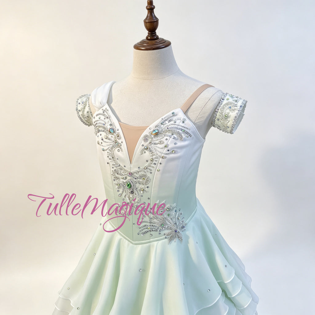High-quality Water Spring ballet variation dress, highlighting a unique tiered wave-like short skirt with lettuce edges, double off-the-shoulder arm bands, and a sparkling central green gemstone