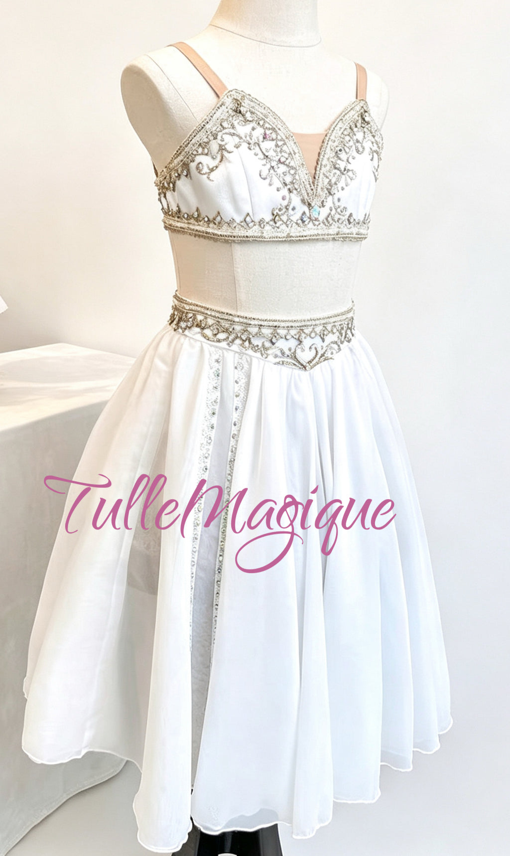 ⁠TulleMagique professional temple dancer style ballet dress featuring an embroidered silver waist band and white chiffon skirt with light golden appliqués