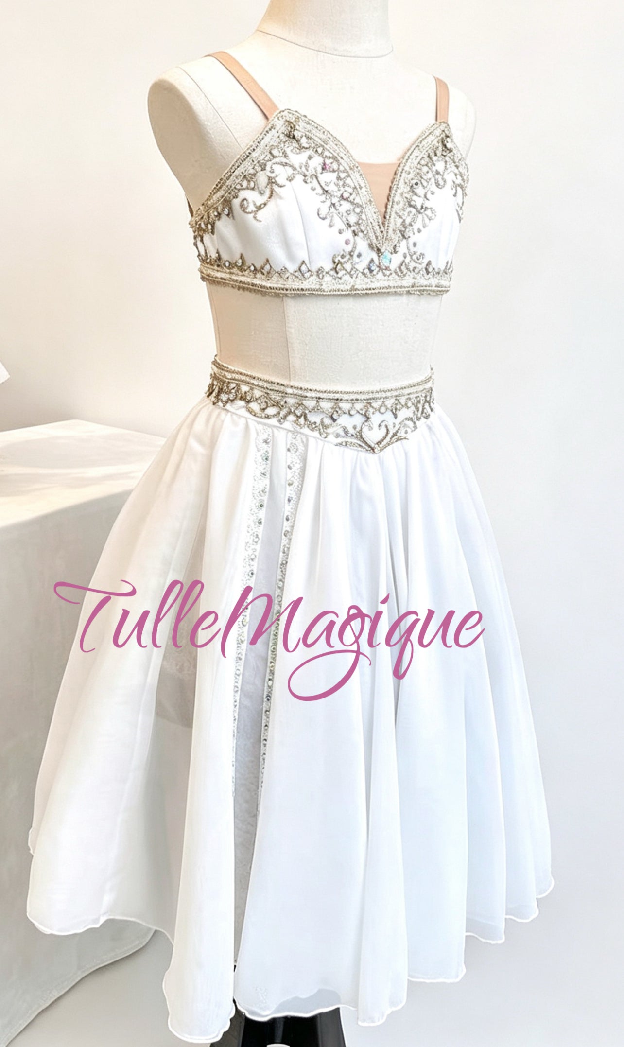⁠TulleMagique professional temple dancer style ballet dress featuring an embroidered silver waist band and white chiffon skirt with light golden appliqués