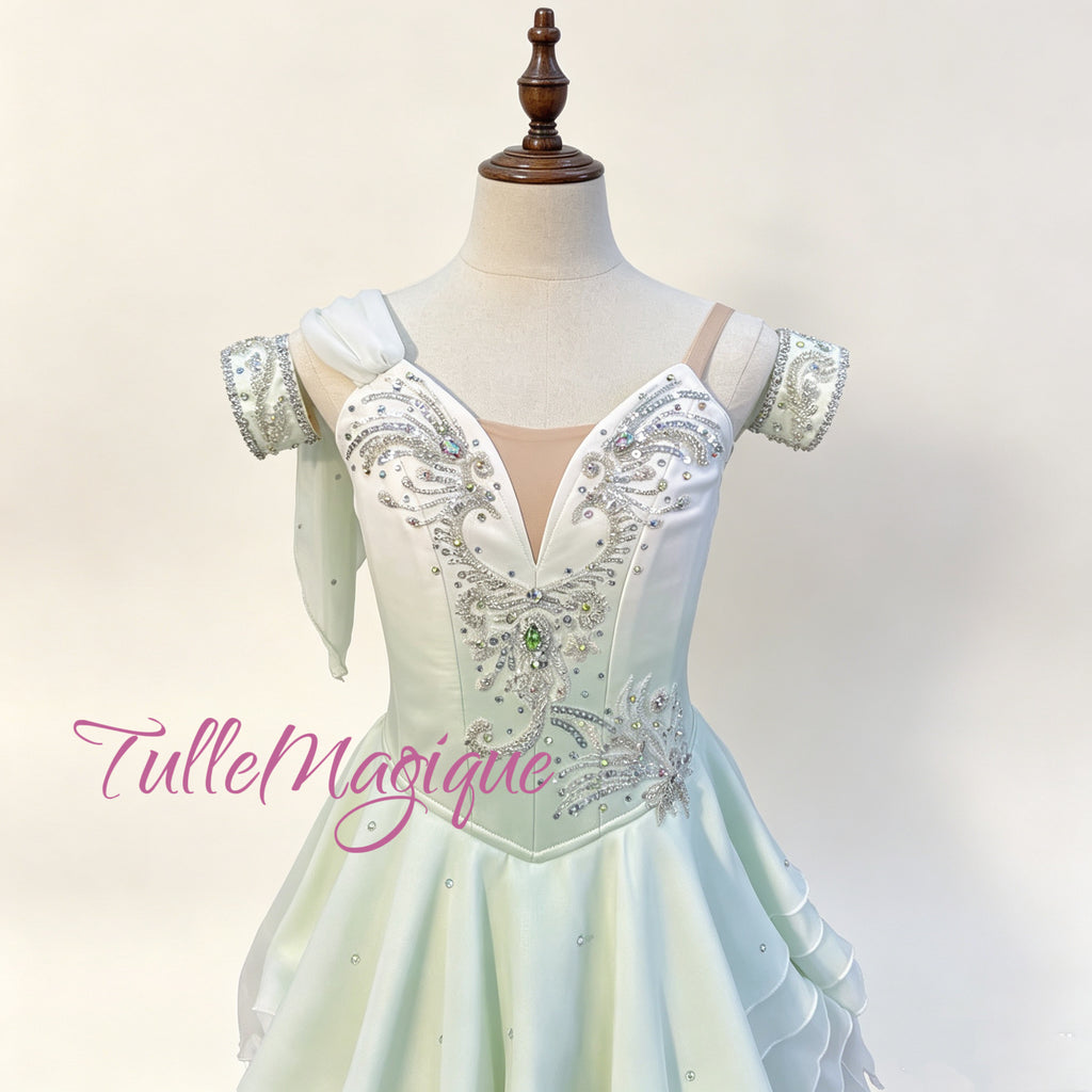 Symmetrical classical ballet tunic for Dew Drop fairy solo, showcasing a white-to-light-green gradient palette, exquisite baroque silver rhinestone bodice embellishments, and a multi-layered wavy snow chiffon skirt.